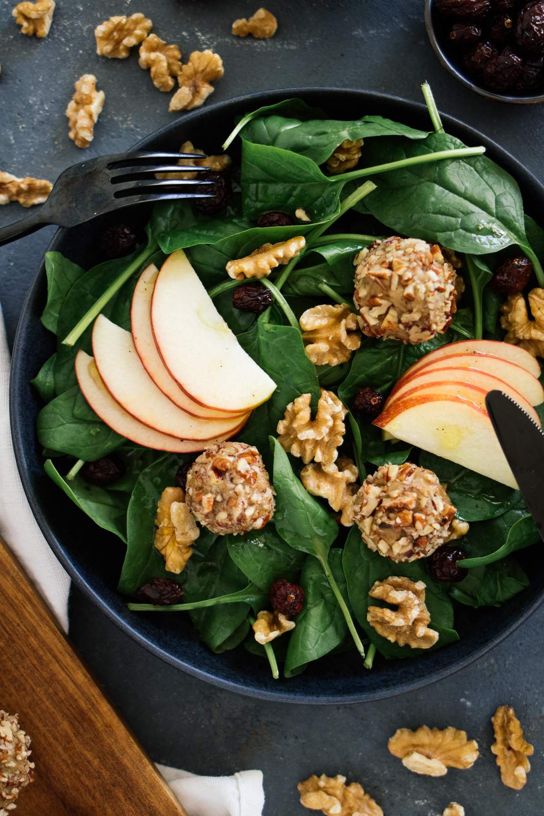 R129 vegan cheese balls on a salad with apple & cranberry