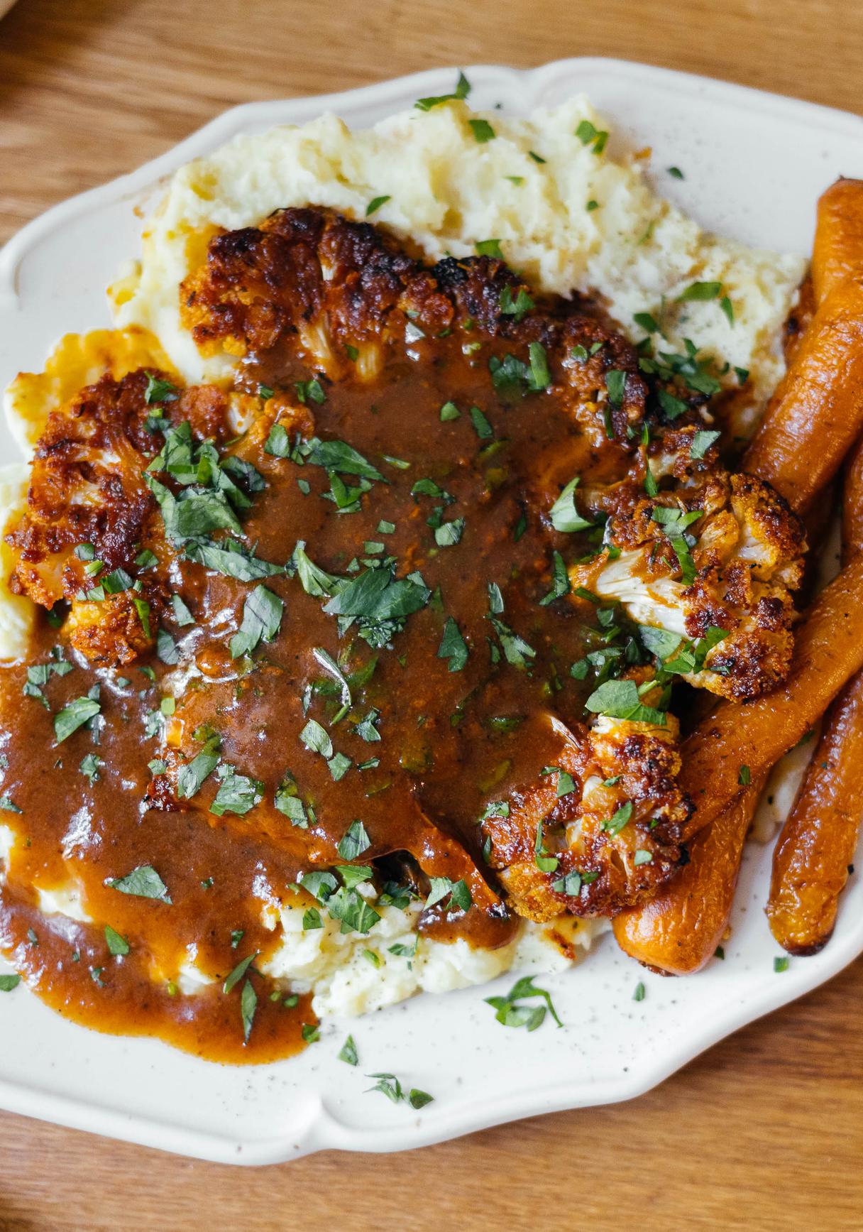 Baked Cauliflower with Mashed Potatoes, glazed Carrots and Vegan Gravy