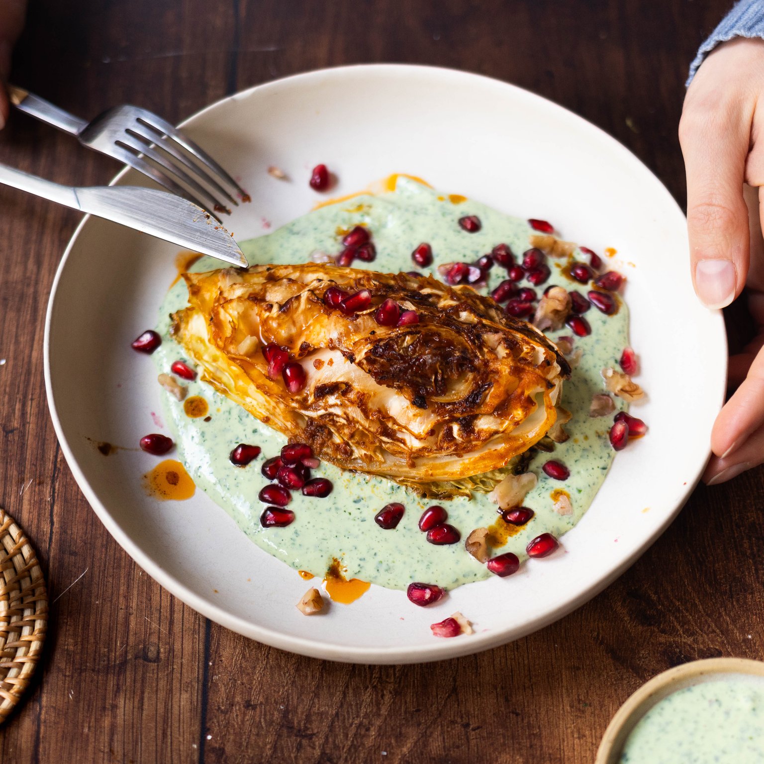 Baked cabbage with herb yogurt and walnut-pomegranate topping