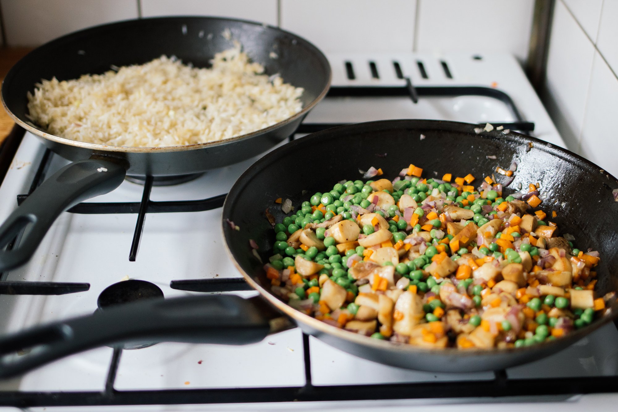 rice and vegetables are fried in pans