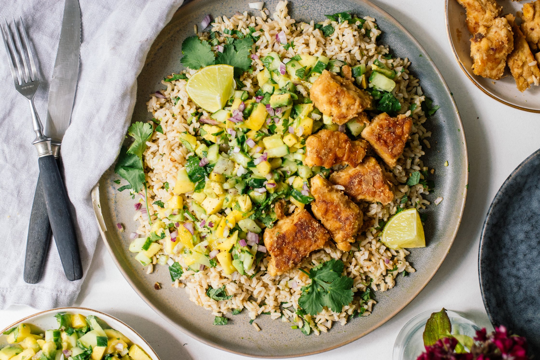 Lime rice with tempeh and mango avocado salsa served on a plate