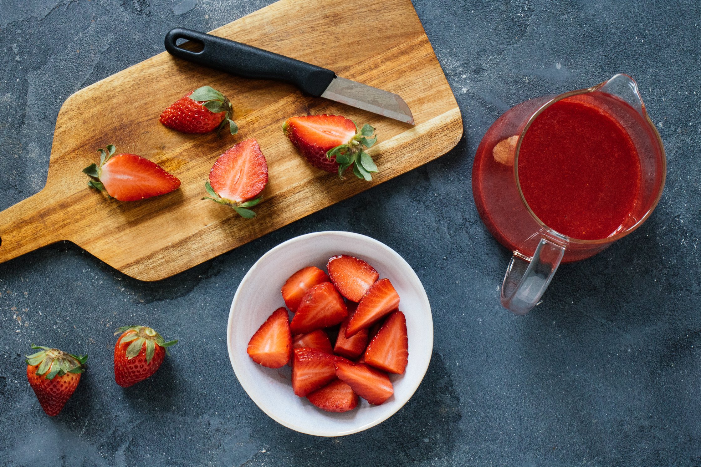 cutting strawberries for a strawberry sauce