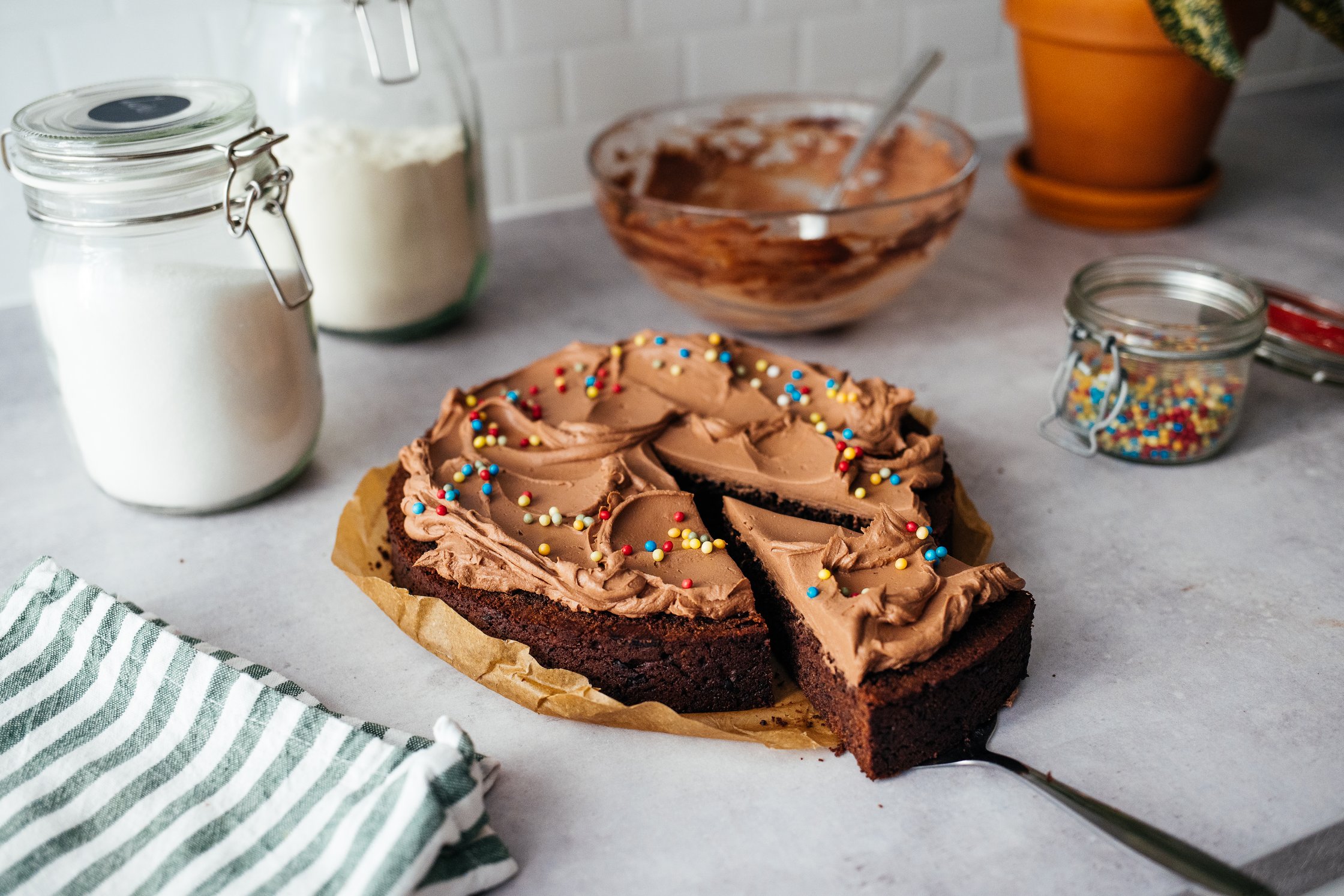 vegan chocolate cake with sprinkles and frosting