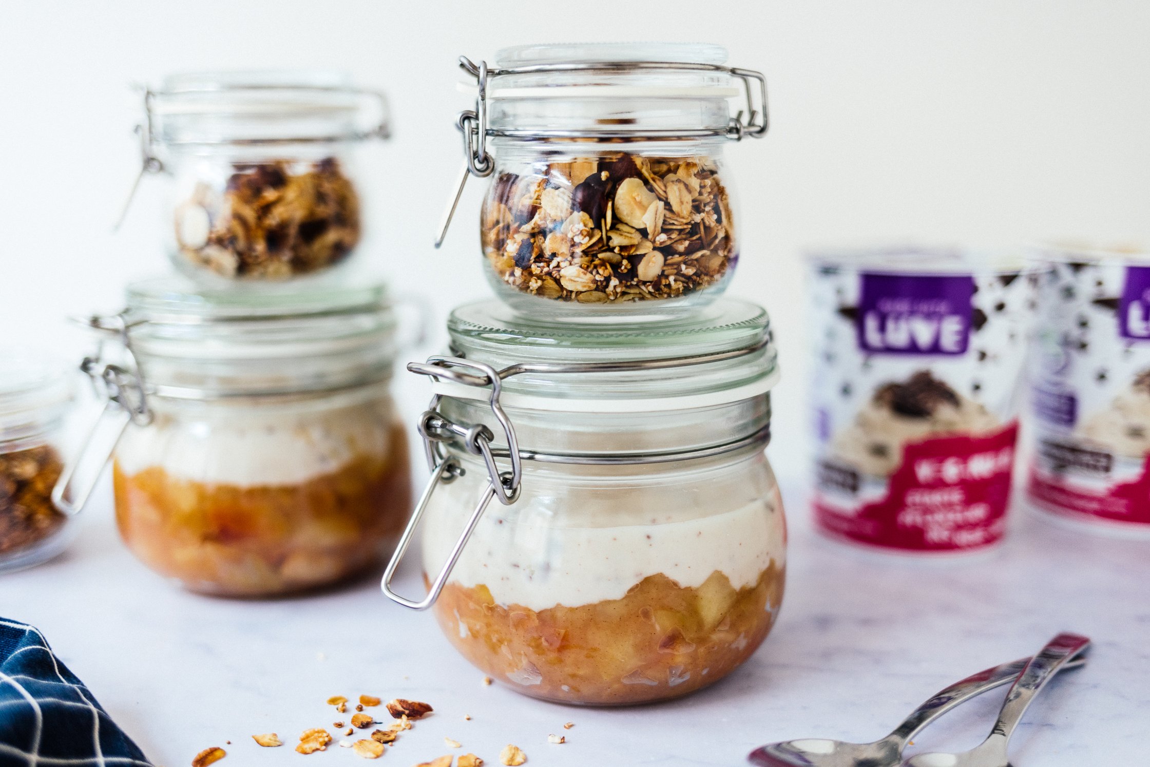 vegan stracciatella yoghurt with granola and apple sauce in a jar