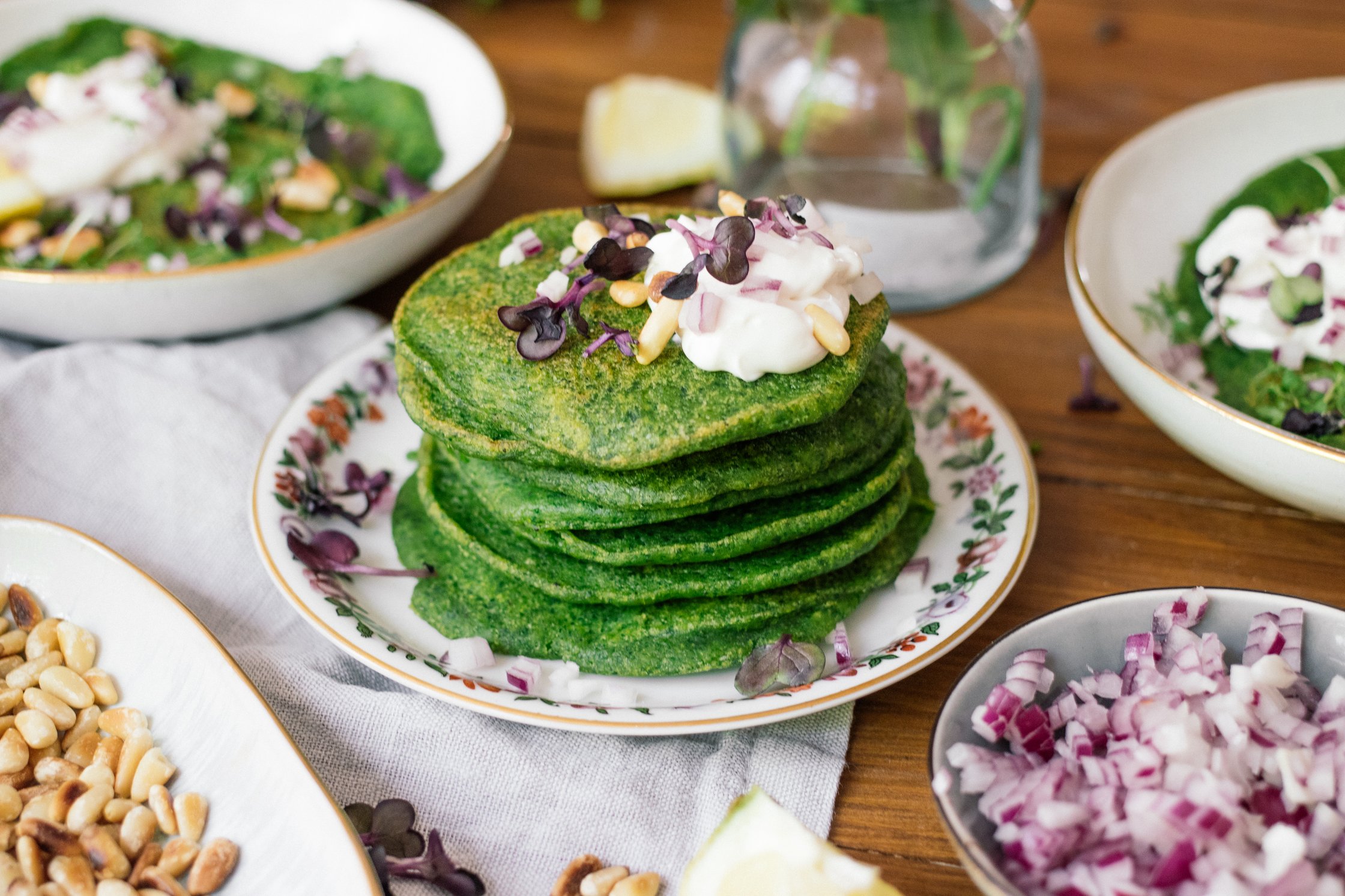 vegan spinach pancakes served with toppings
