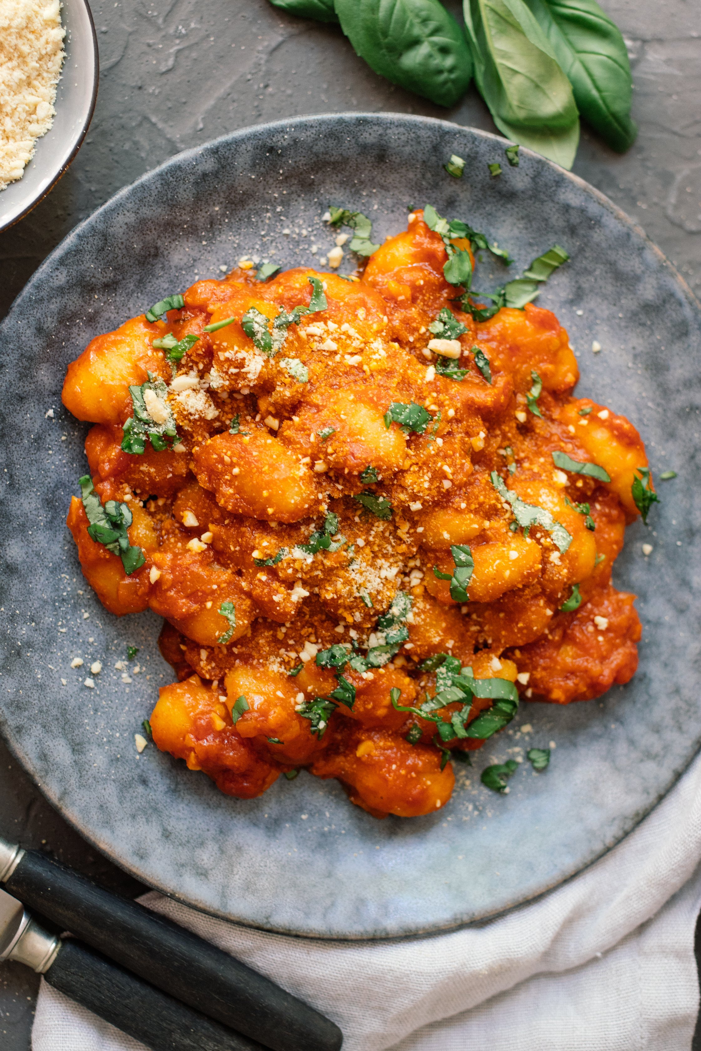 Vegan Gnocchi all arrabbiata on a plate with basil on top