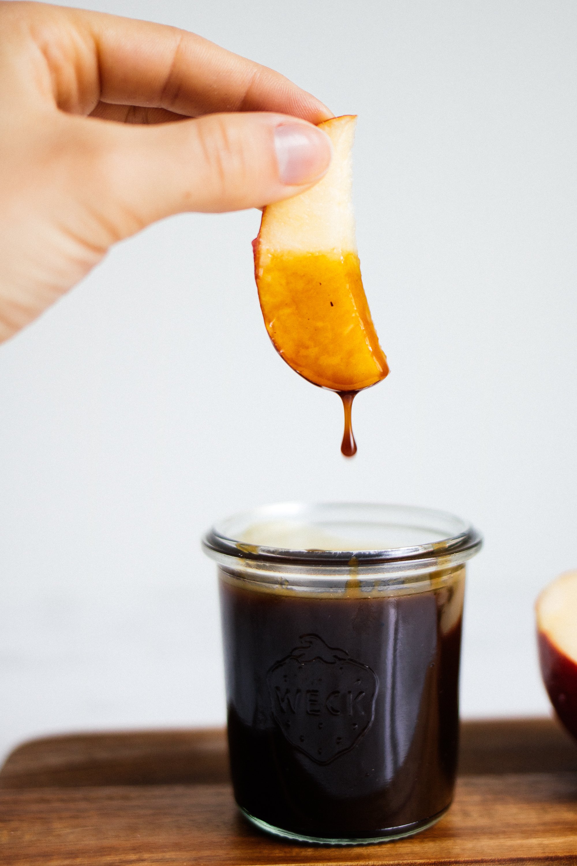 apple slice dipped in vegan caramel