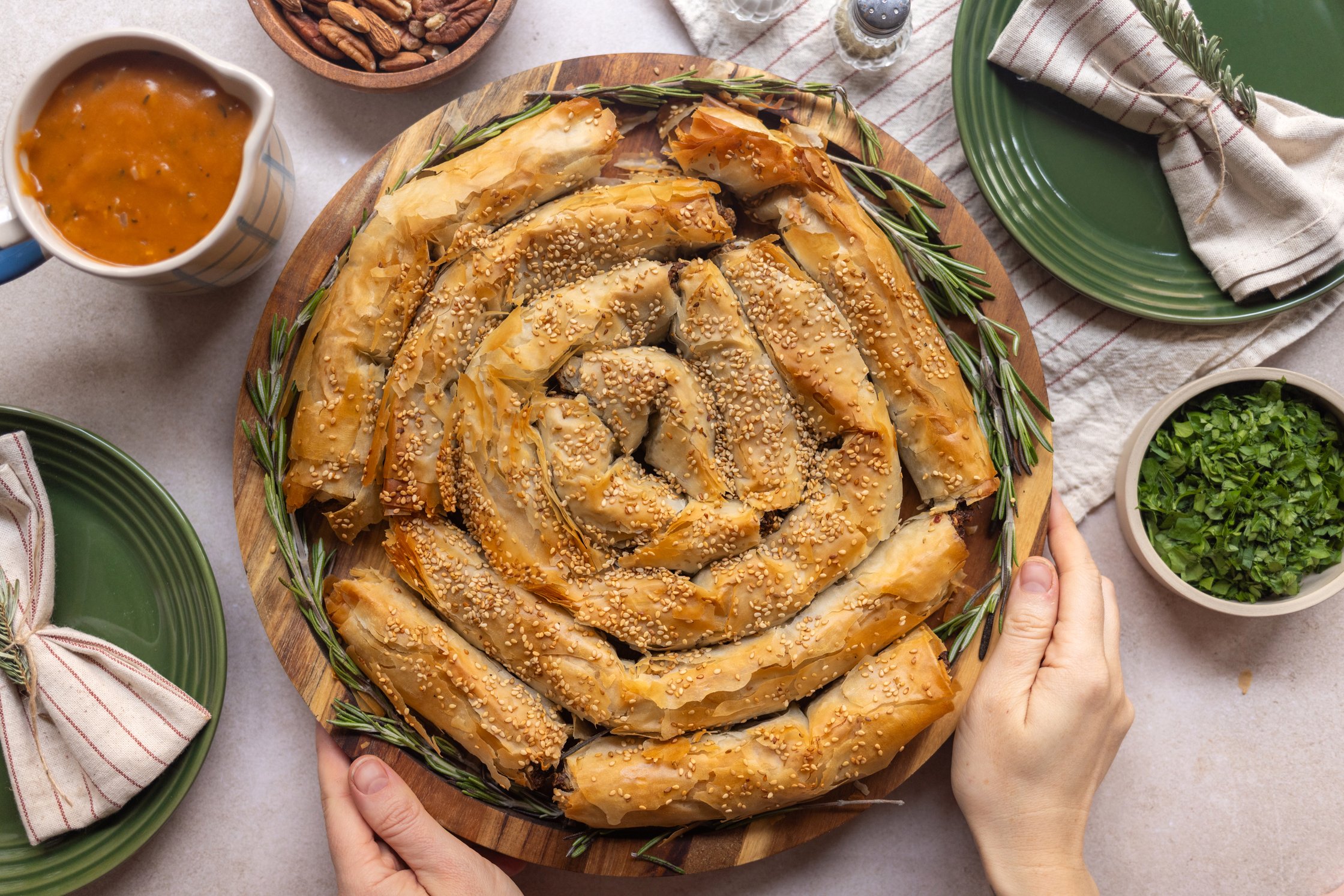 Plant-Based Nut Roast Strudel With Quick Gravy served on the table