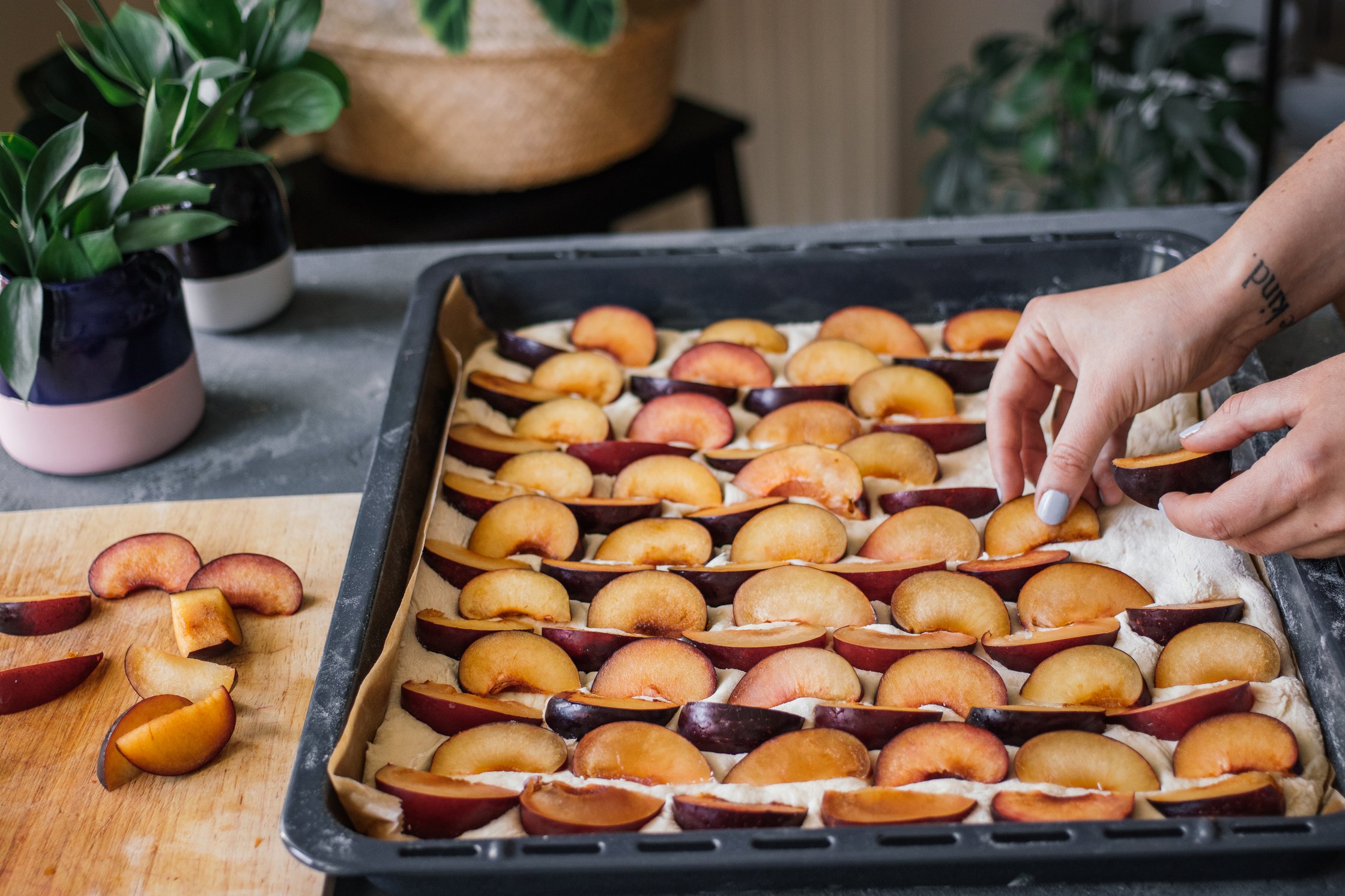 adding plums to yeast dough