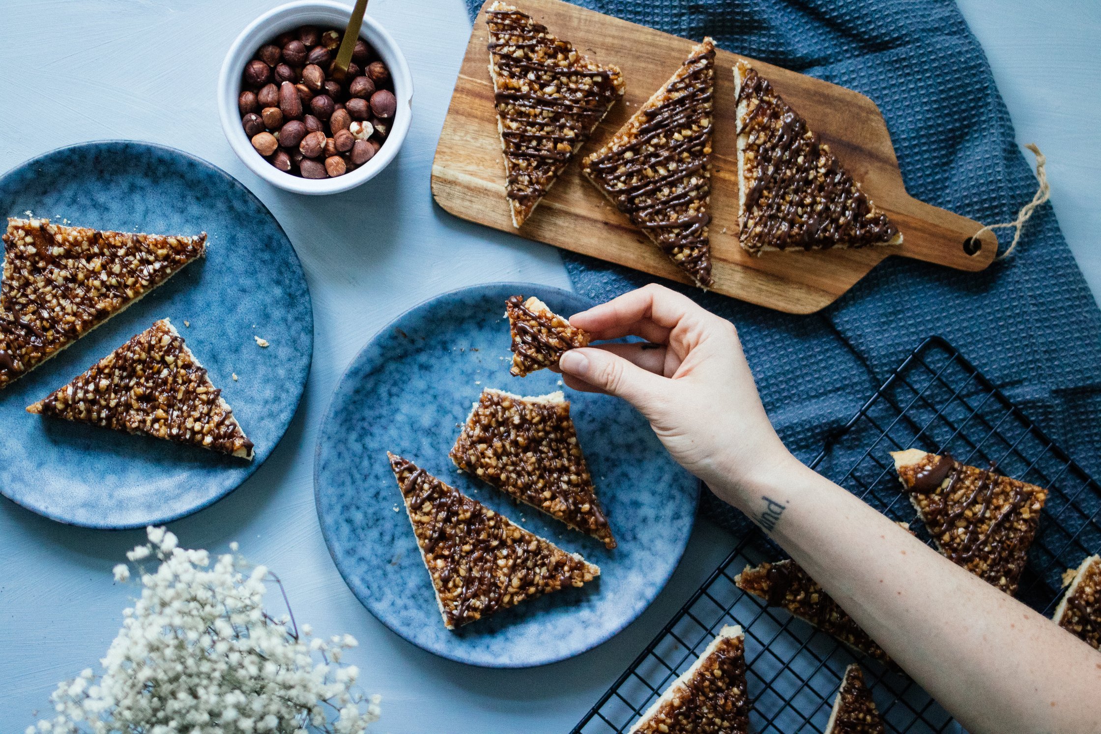 Vegan nut triangles on a blue back drop