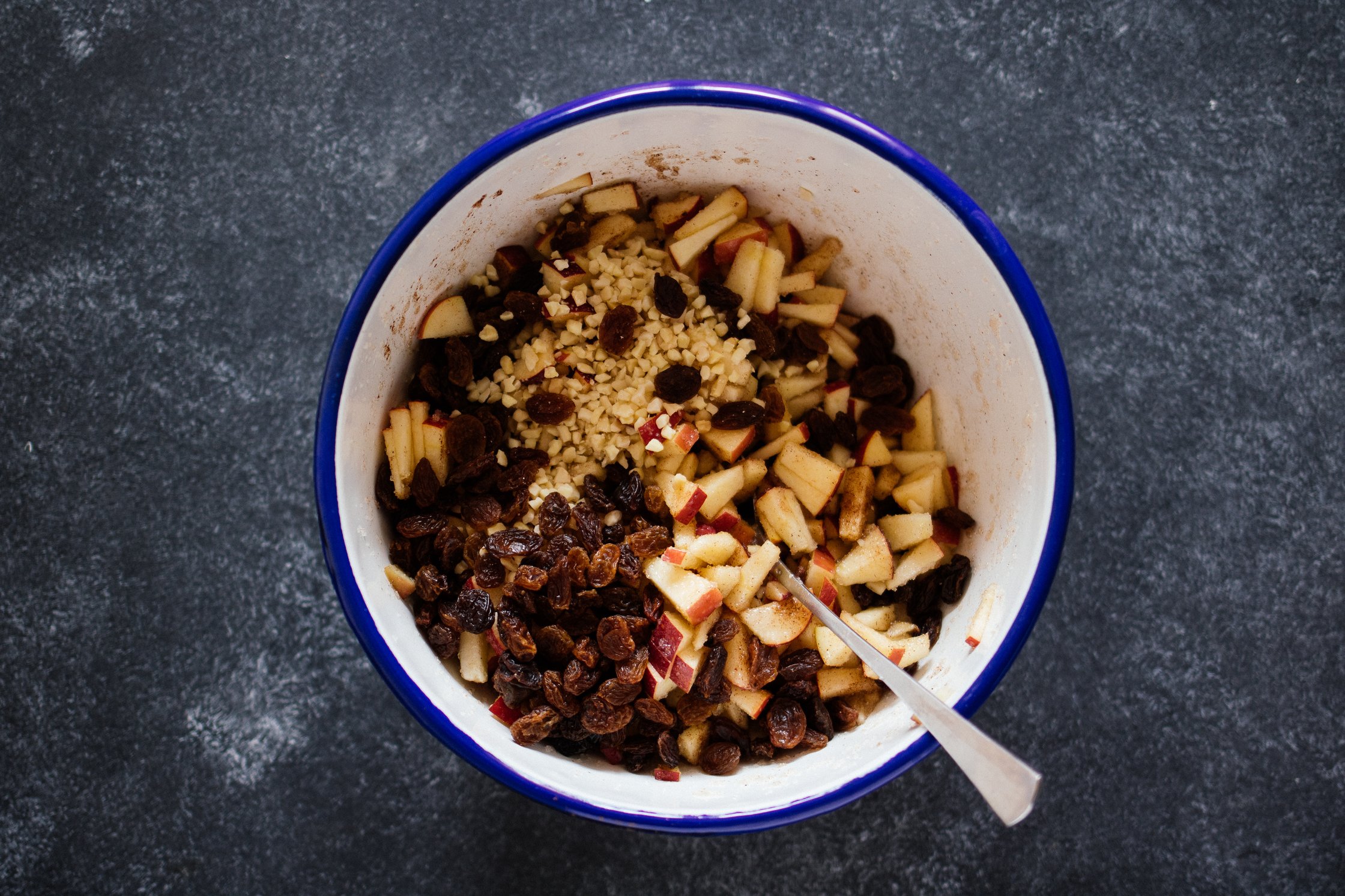 nuts, apples and raisins in a bowl