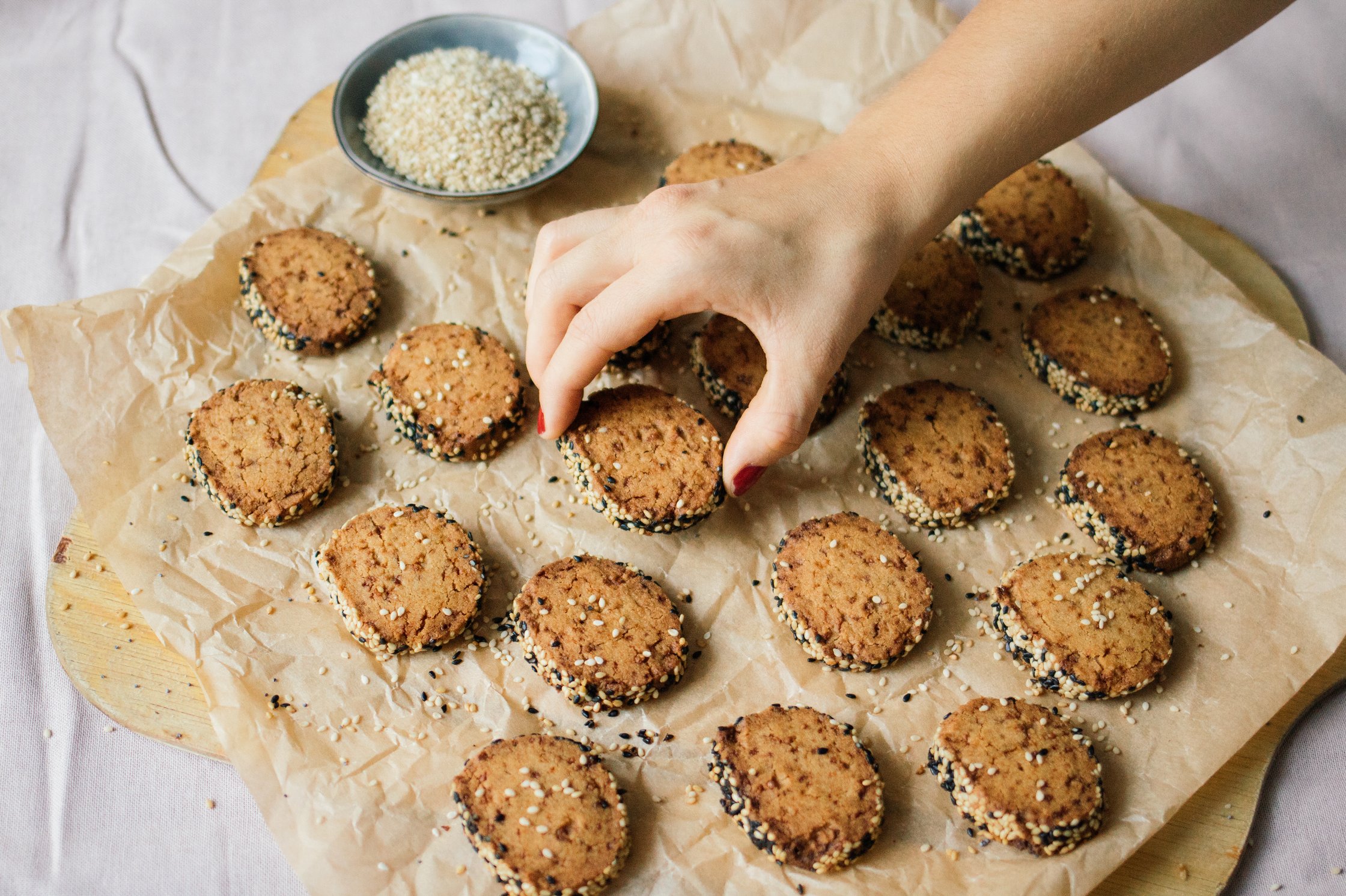 hand grabs a vegan tahini cookie