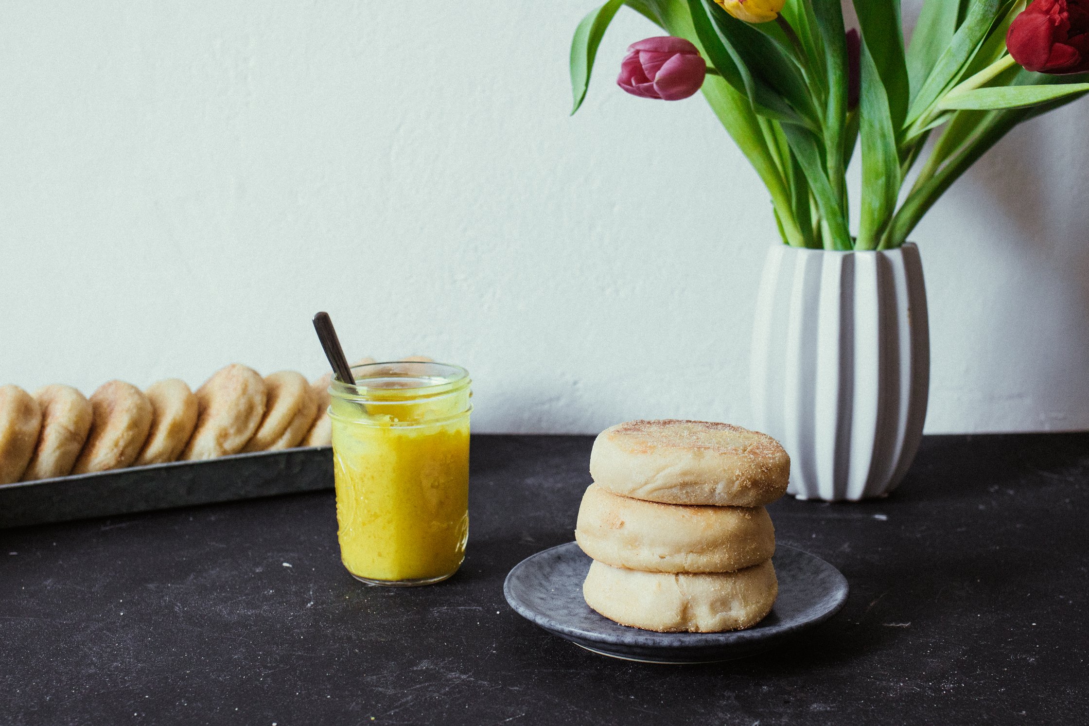 table with tulips, english muffins and lemon curd
