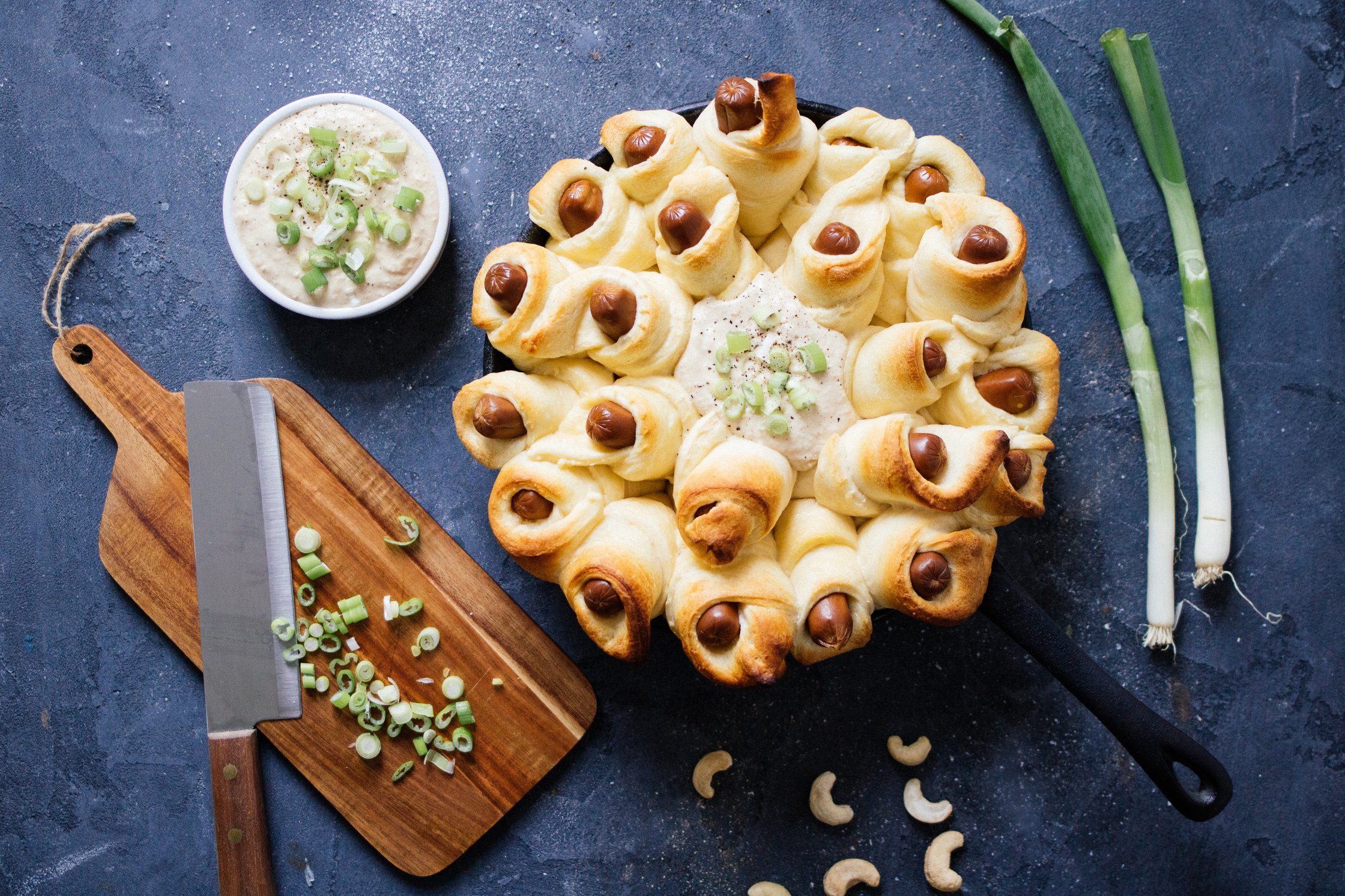 serving pigs in a blanket with onion dip