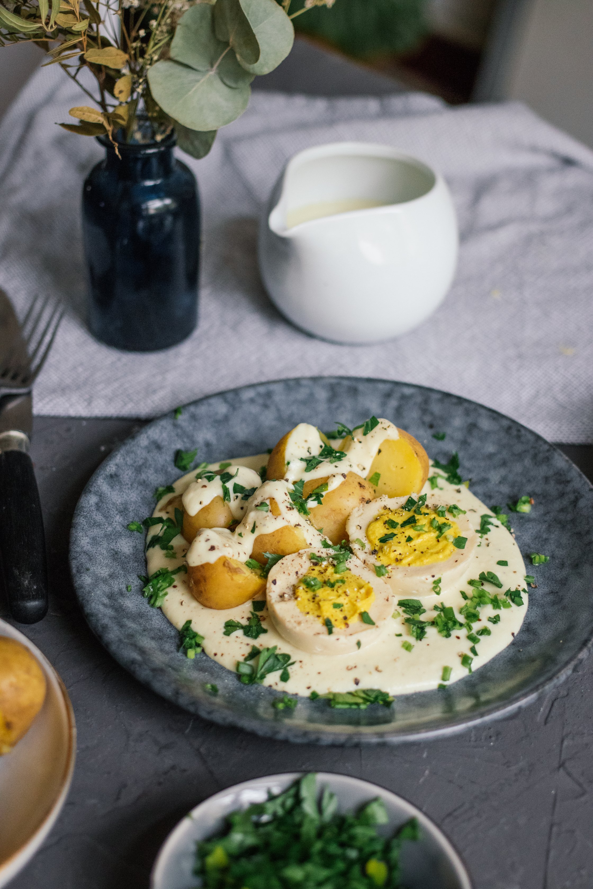 Vegan Boiled Eggs in Creamy Mustard Sauce with Potatoes on a plate