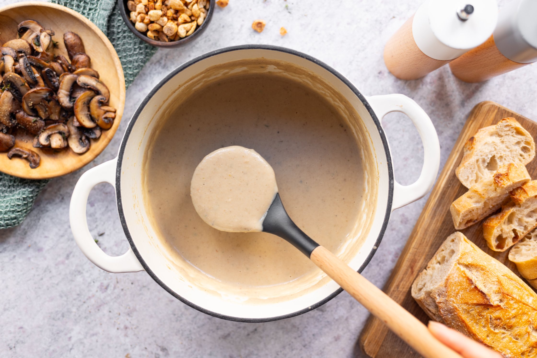 maronensuppe in einem großen topf, mit Suppenkelle, Pilze, Nüsse, brot