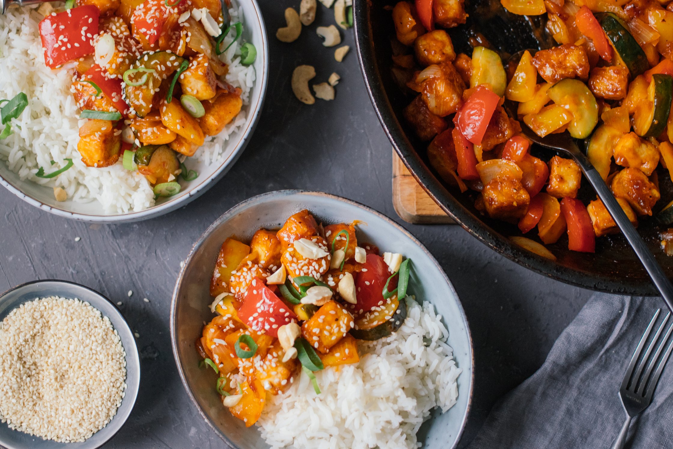 sweet and sour tofu with rice on a table
