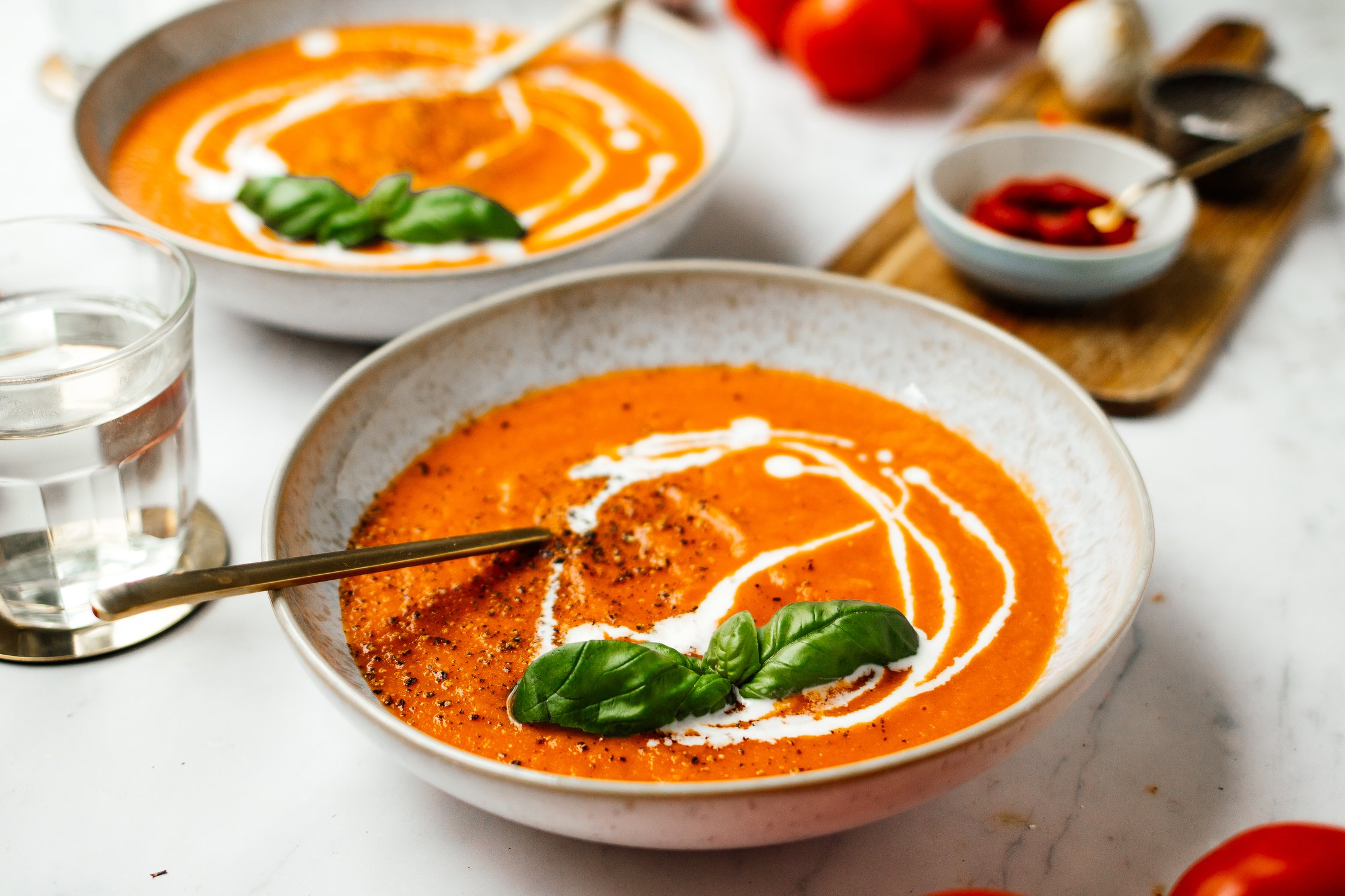 vegan tomato soup with a glas of water