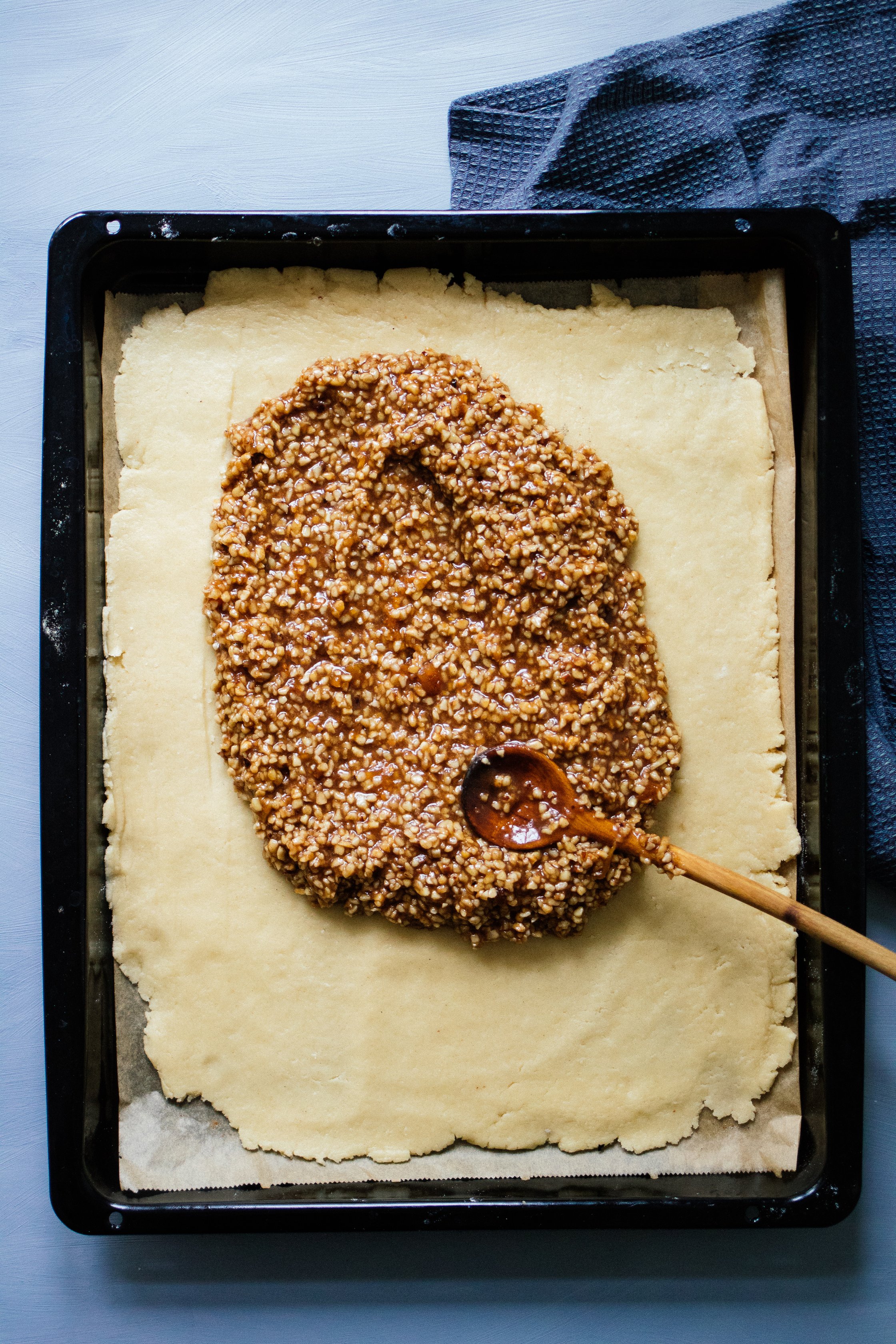 spreading the nut mixture on the vegan dough