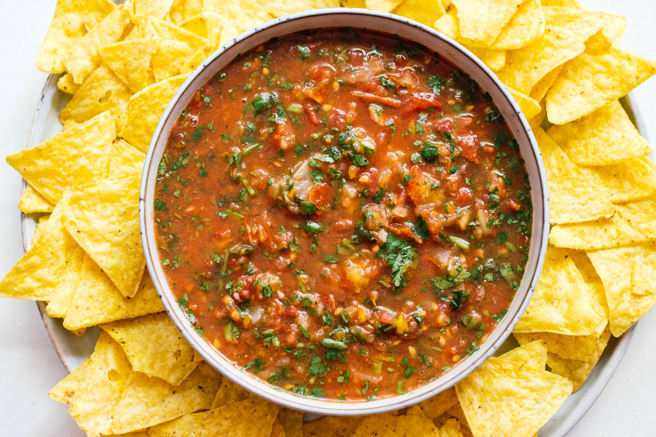 vegan tomato salsa served in a bowl with tortilla chips