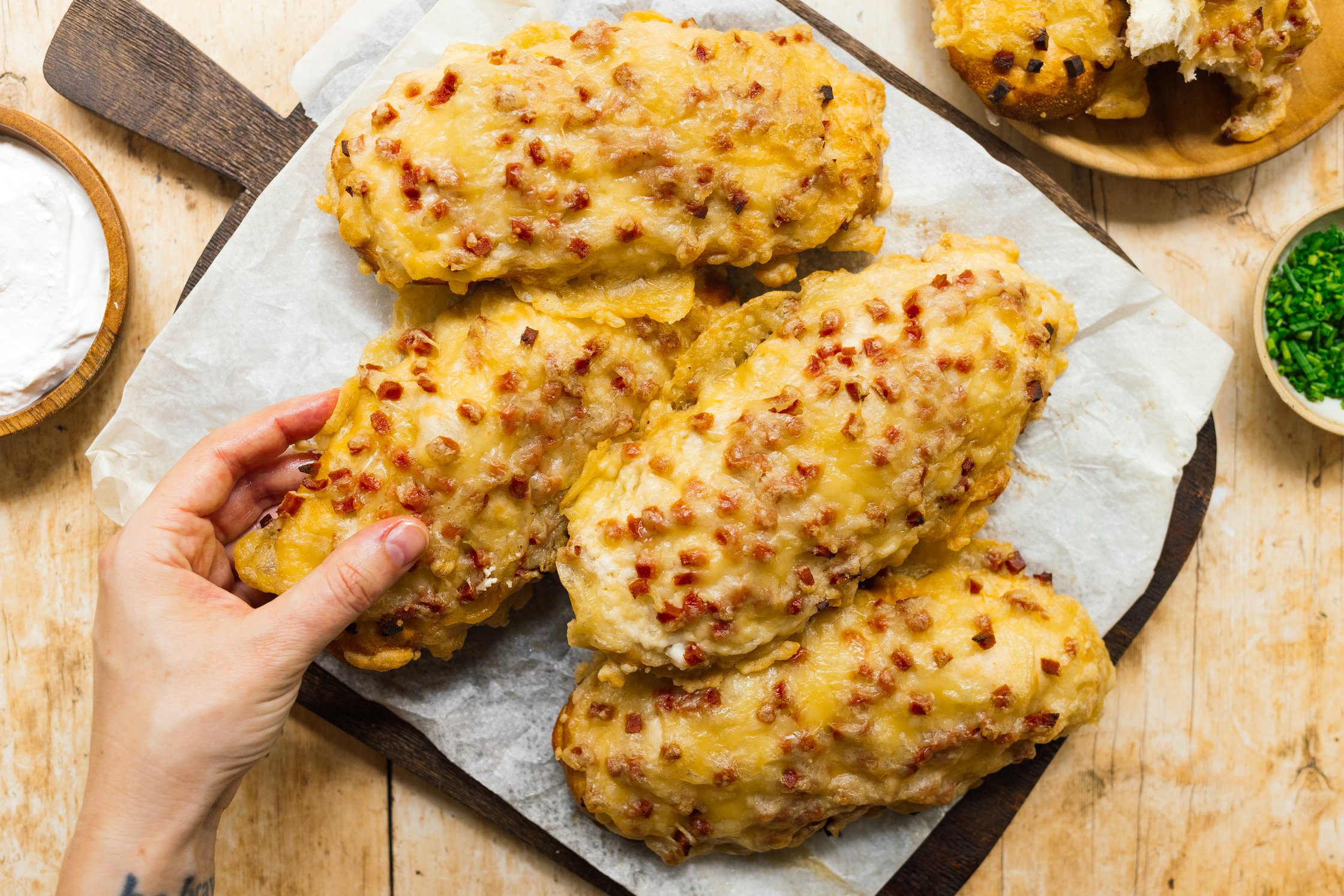 a hand grabs a vegan ham and cheese pretzel stick