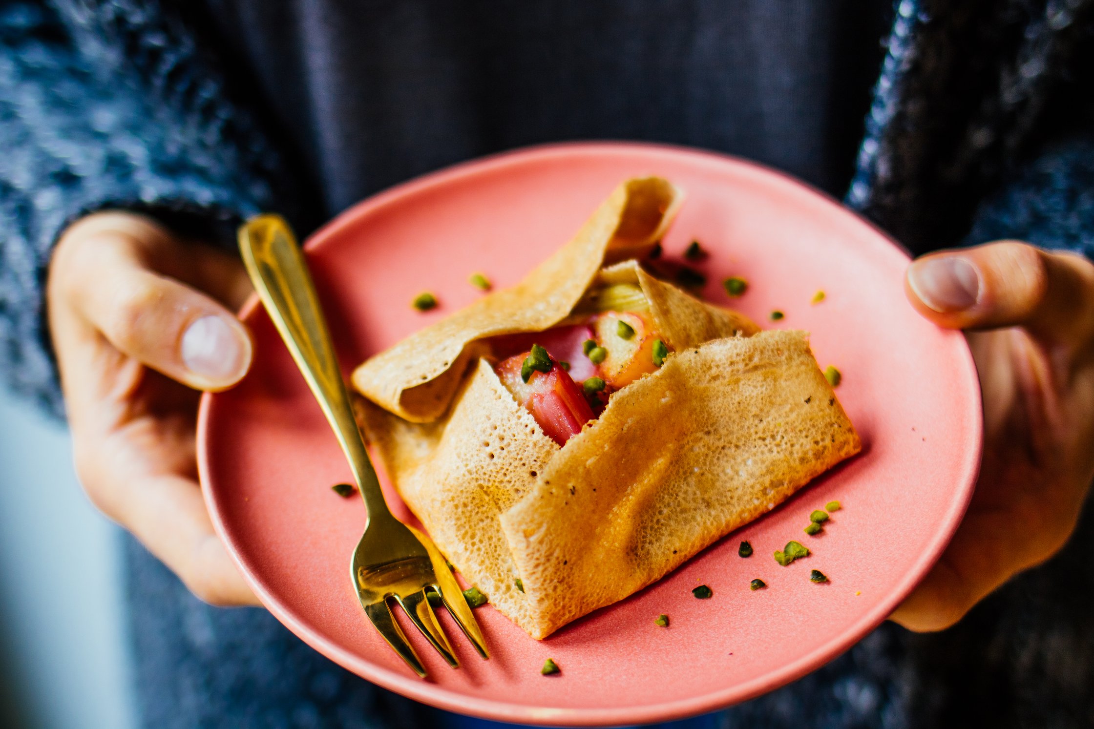 hands holding vegan buckwheat galette