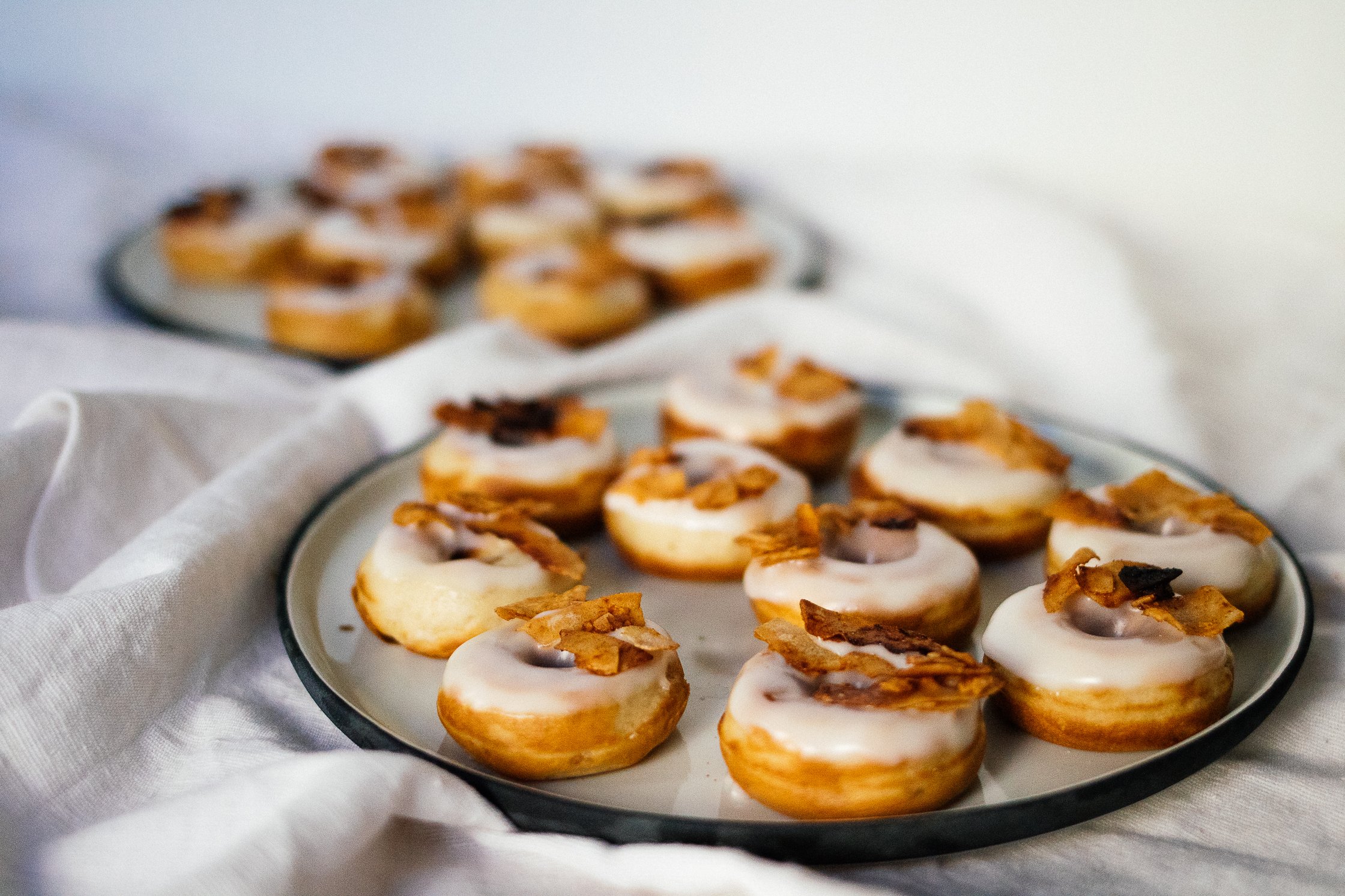 Vegan Bacon Donuts on two plates, photo from the side