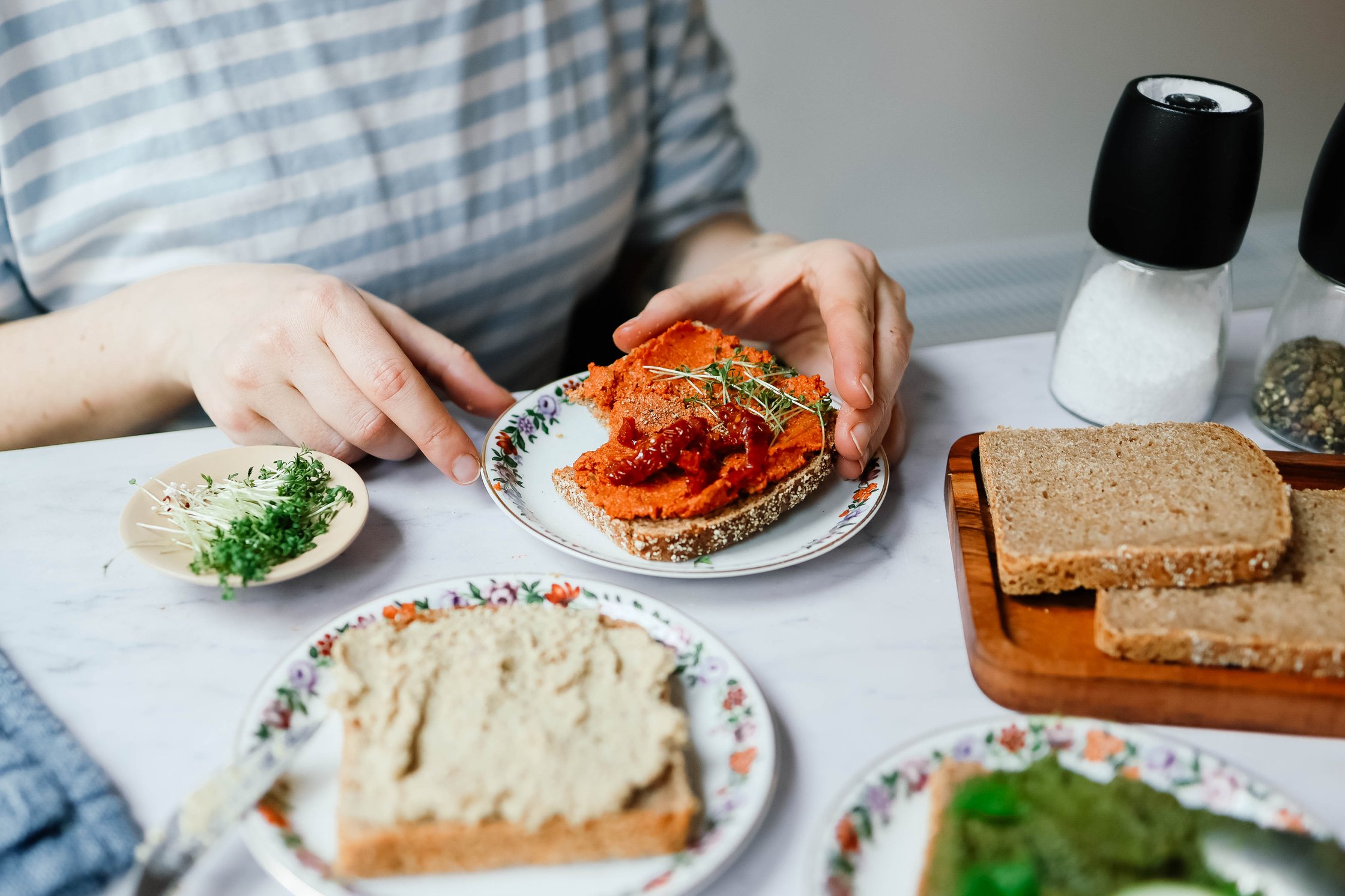 different vegan spreads with bread and vegetables