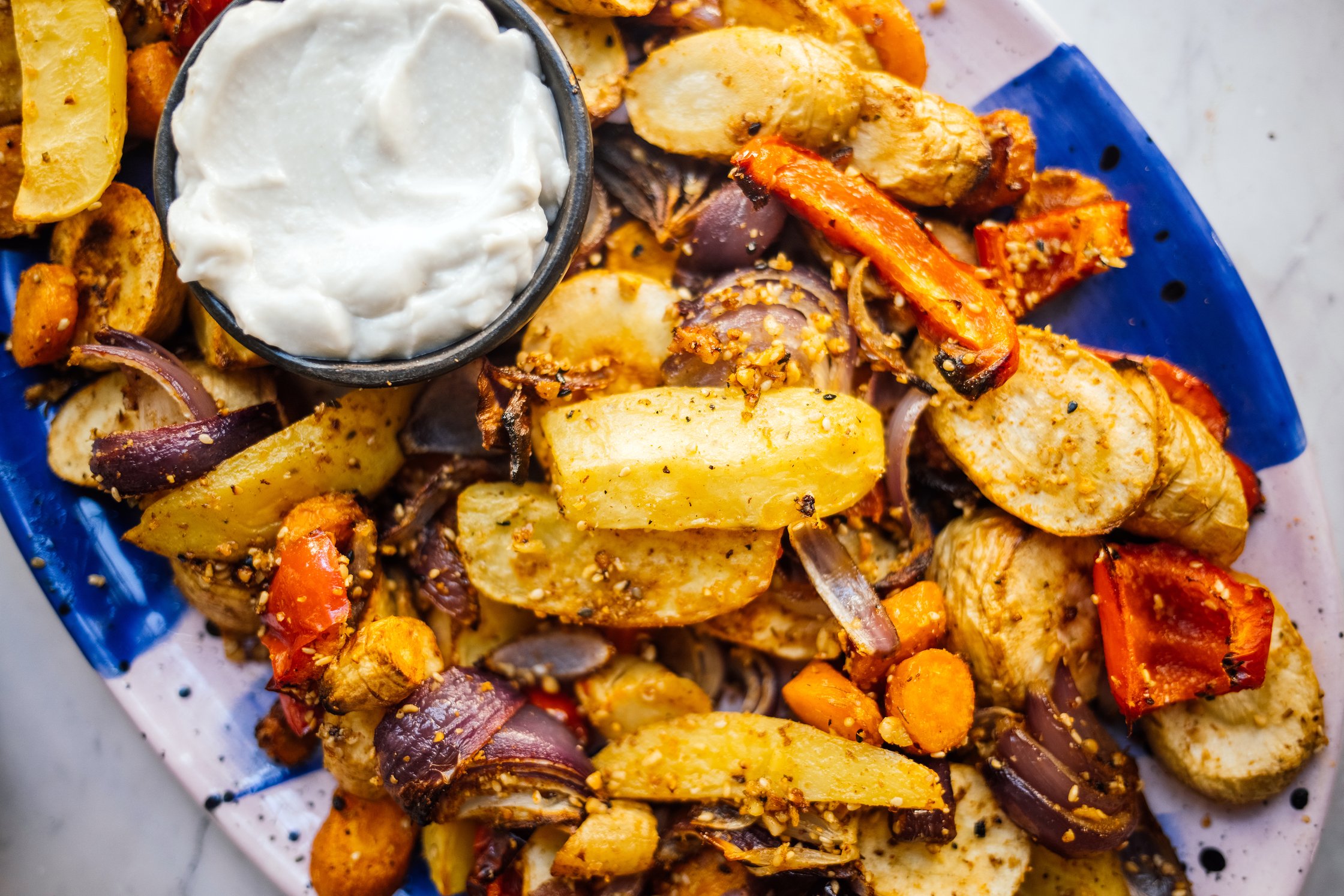 closeup of Baked Vegetables with Dukkah and Toum