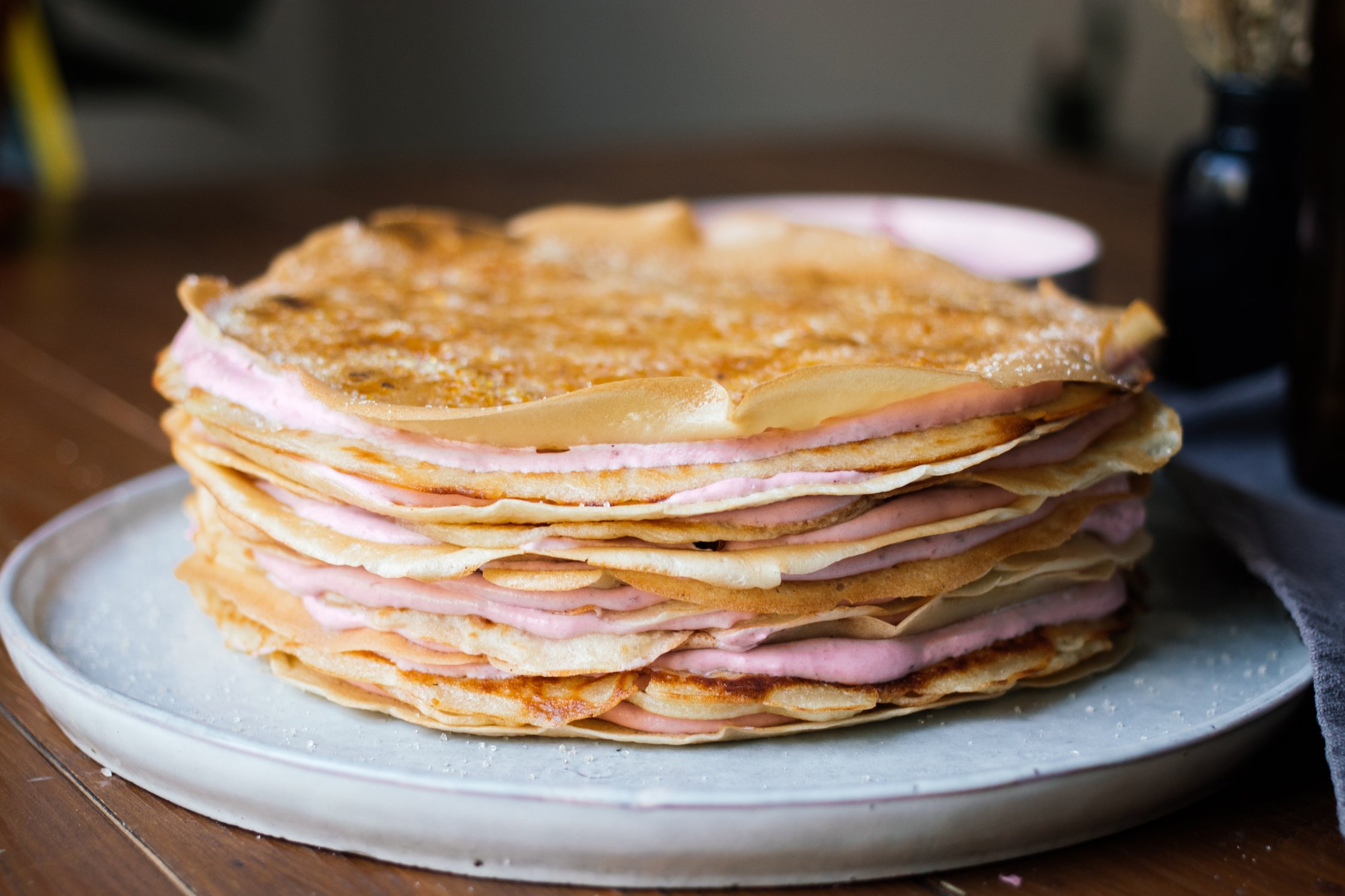 vegan crêpe cake with strawberries served on a platter
