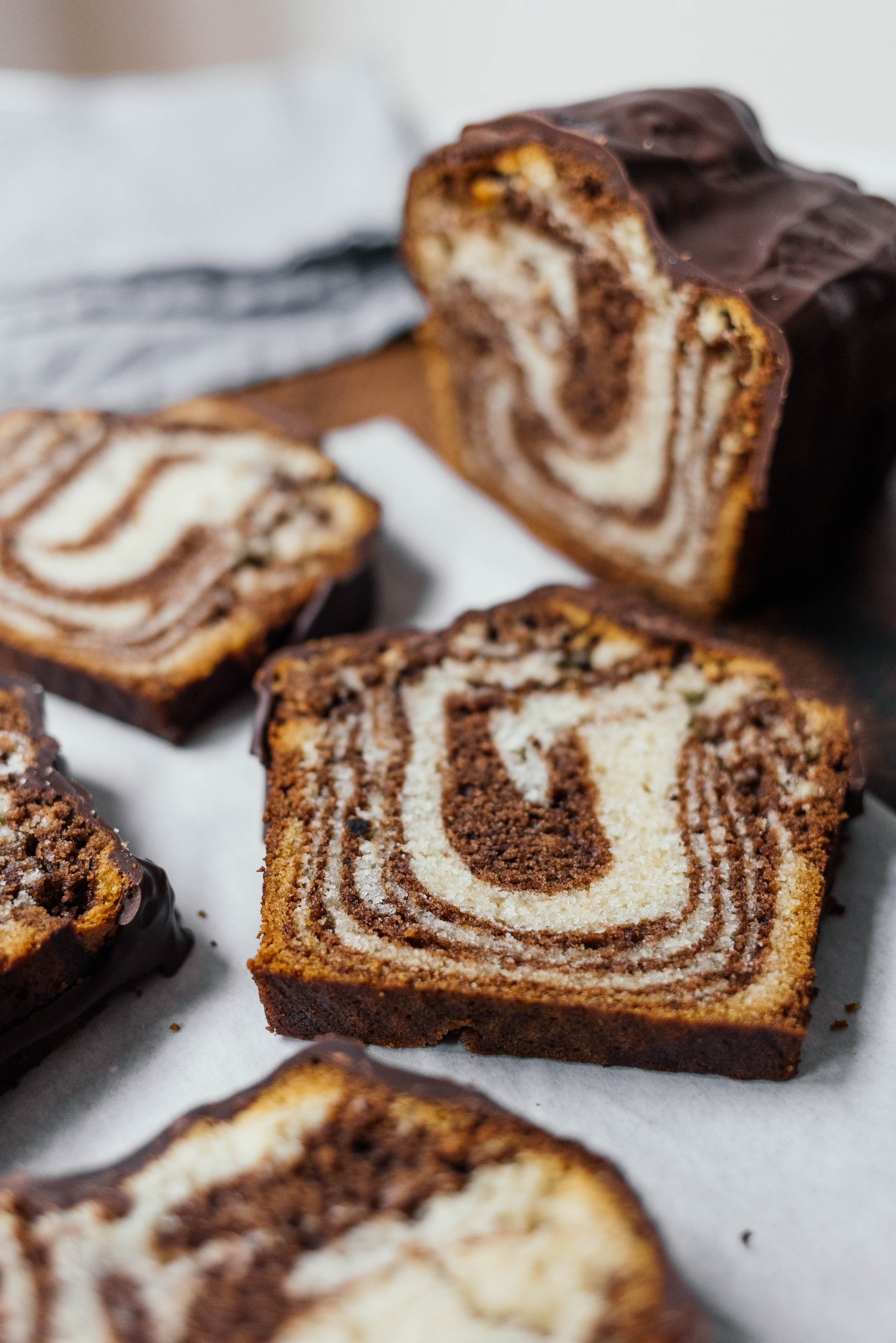 slices of vegan marble cake with chocolate glaze