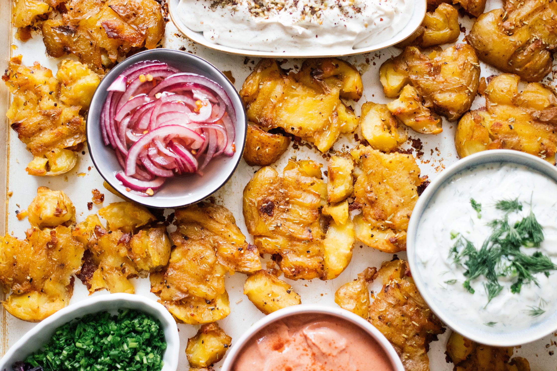 closeup of Crispy Baked Smashed Potatoes with Vegan Dips