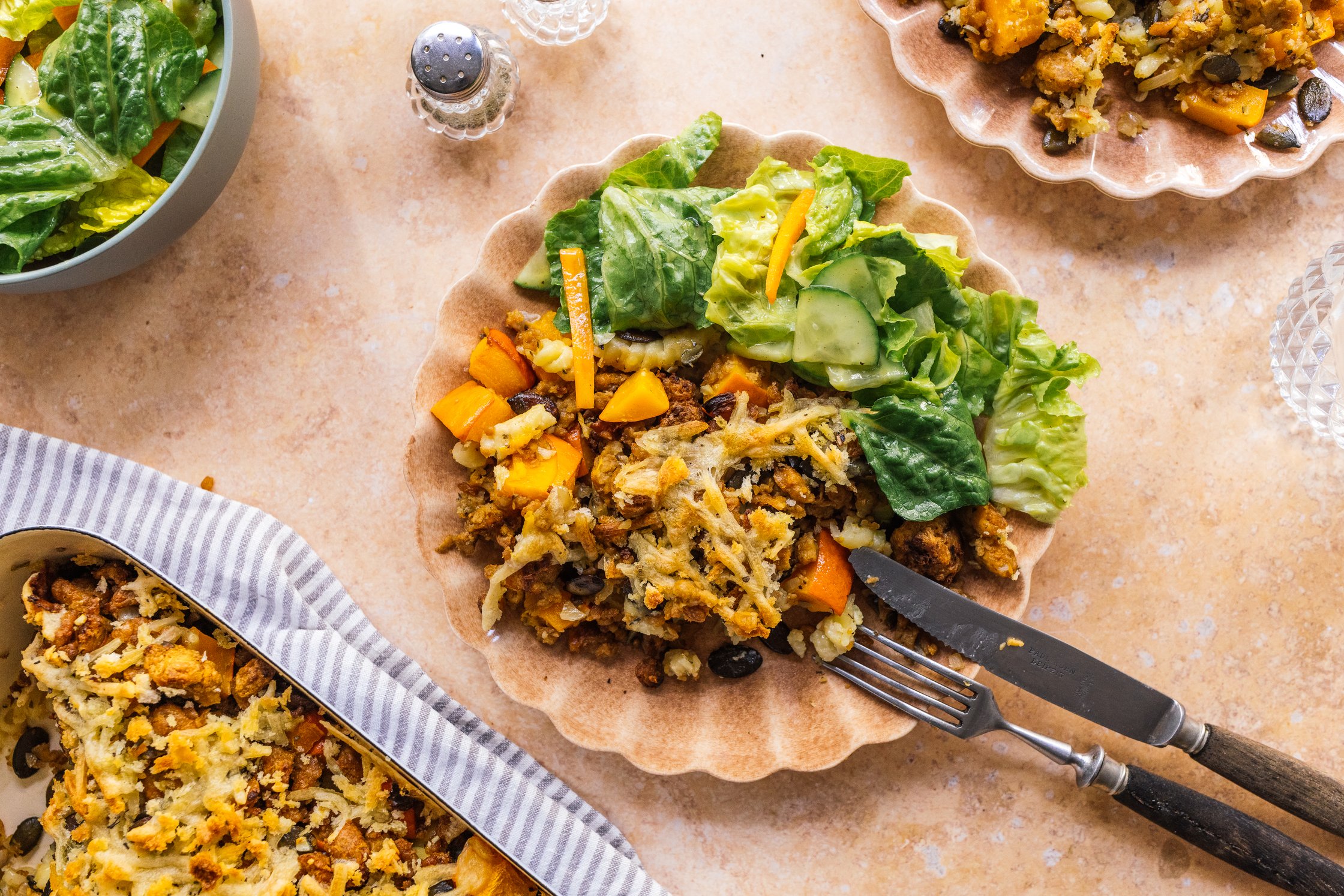 vegan pumpkin casserole on a plate with salad