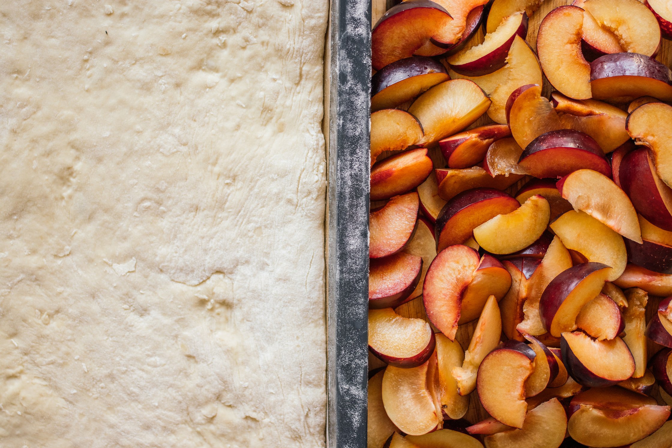 yeast dough and plums next to each other