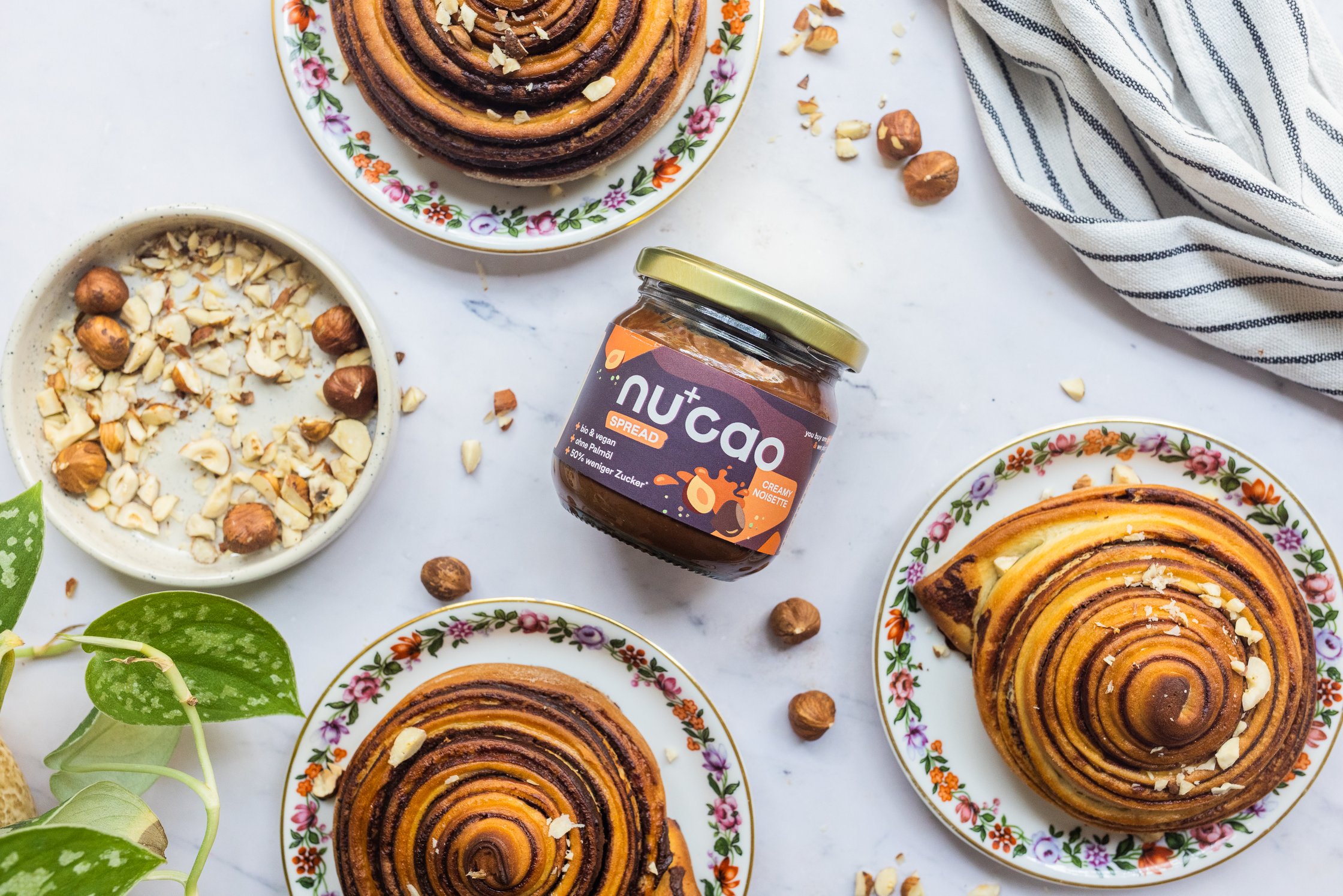 a jar of vegan chocolate spread in between baked Vegan Chocolate Swirl Buns
