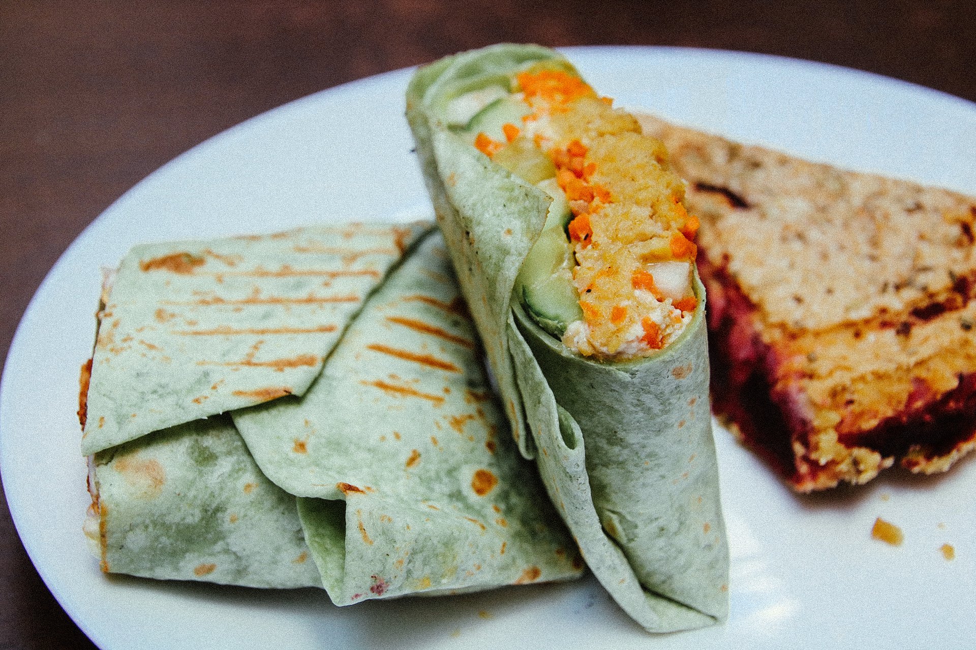 a quiche and a wrap on a white plate