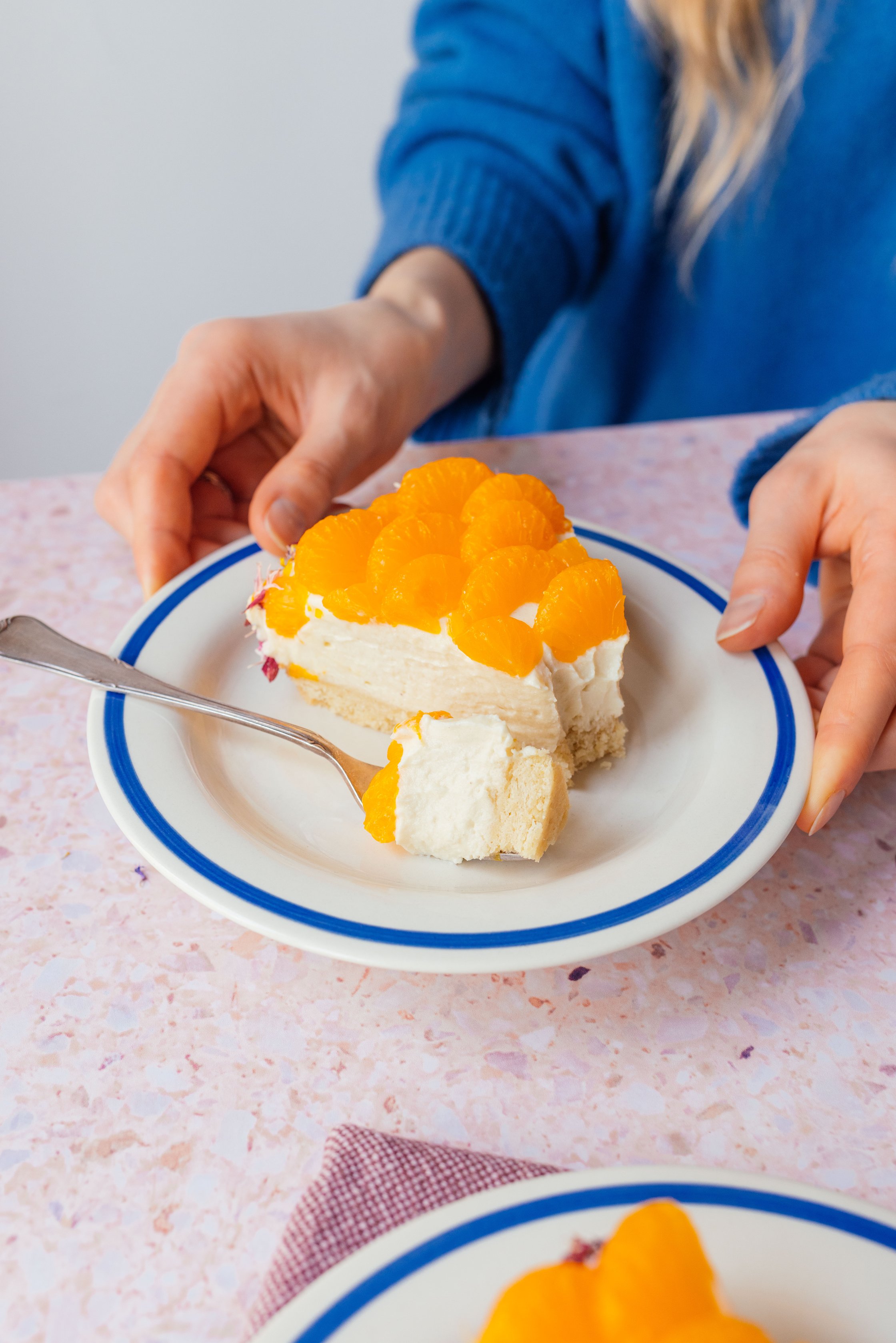 vegan cream and mandarin cake with flower coating on a plate