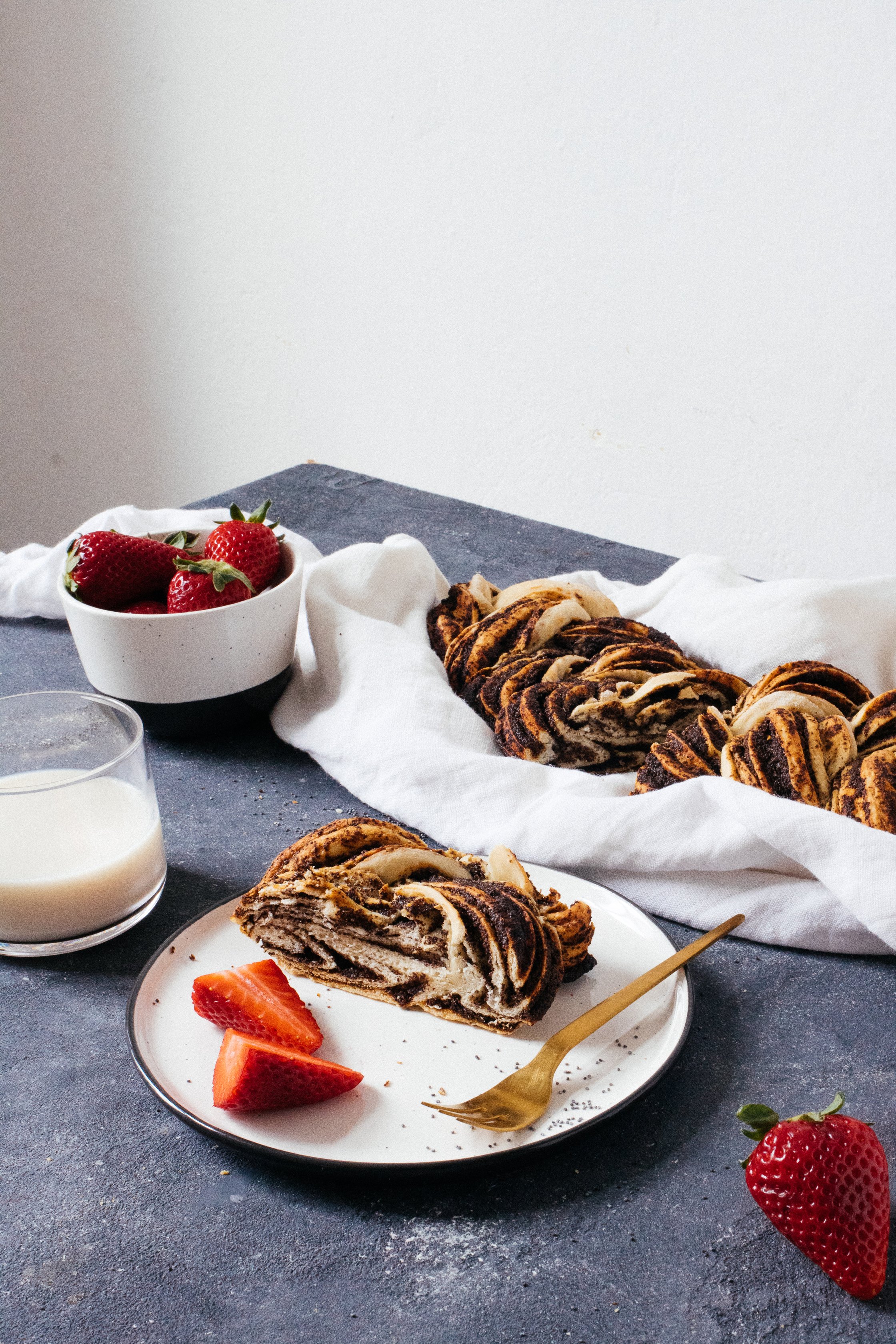 braided loaf with strawberries on a plate