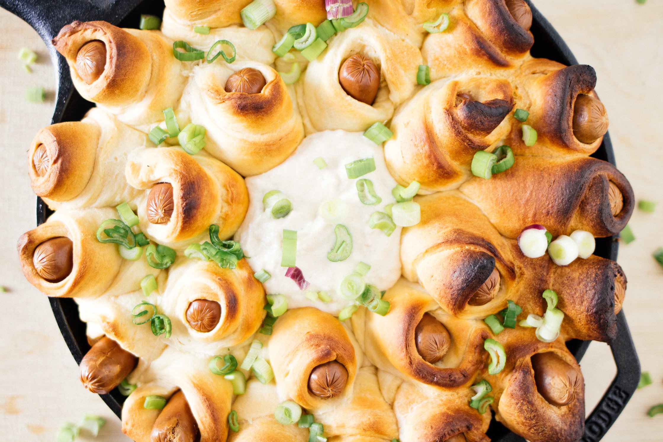 vegan pigs in a blanket topped with green onions