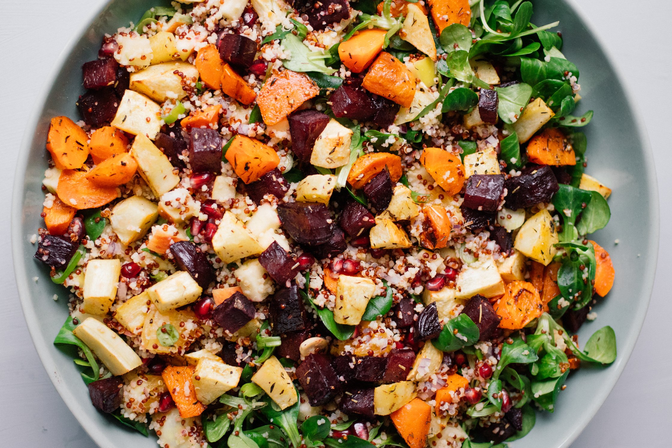 close up of Winter Salad with Couscous, Quinoa, Roasted Veggies and Turmeric Dressing