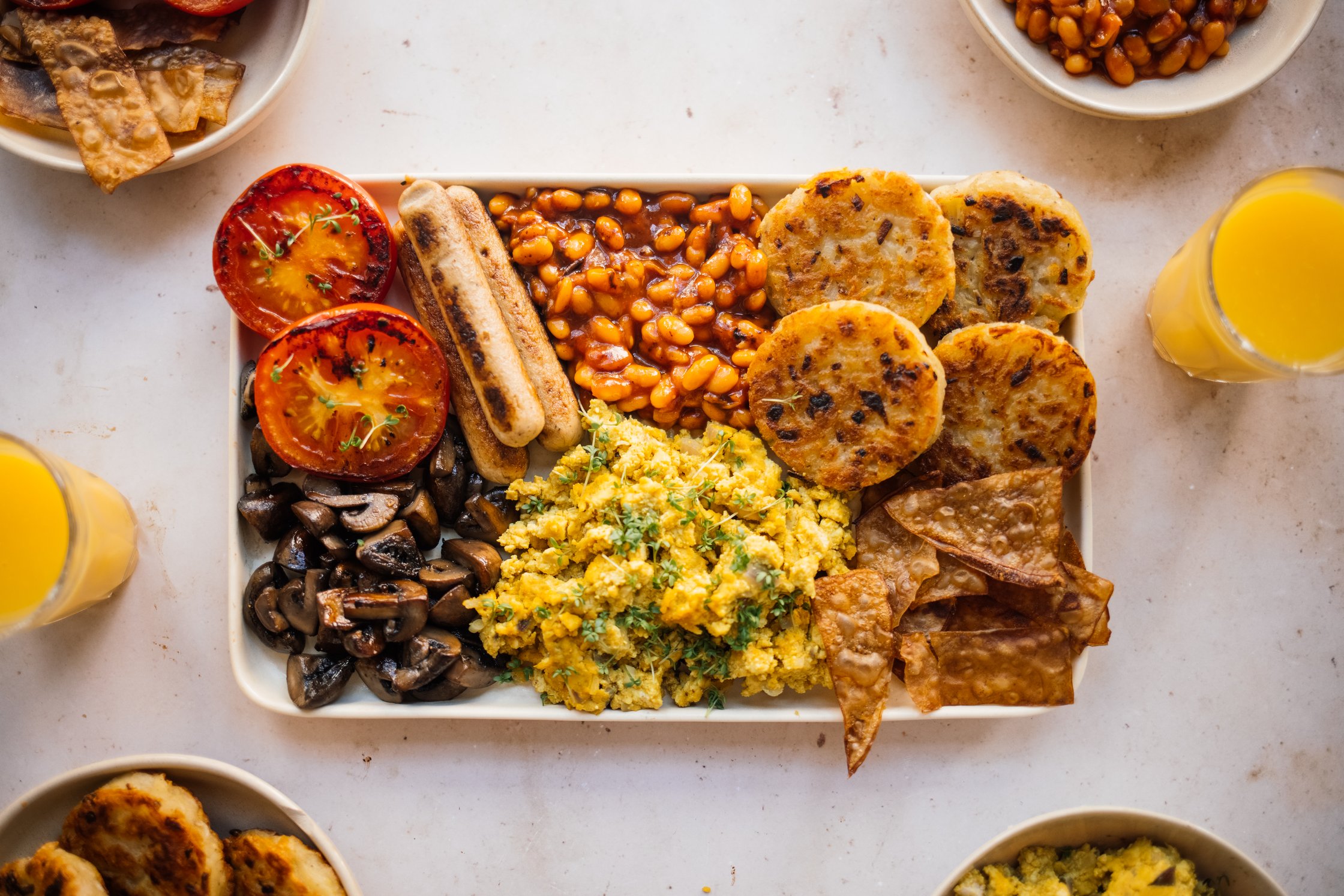 Vegan English Breakfast with orange juice on a table