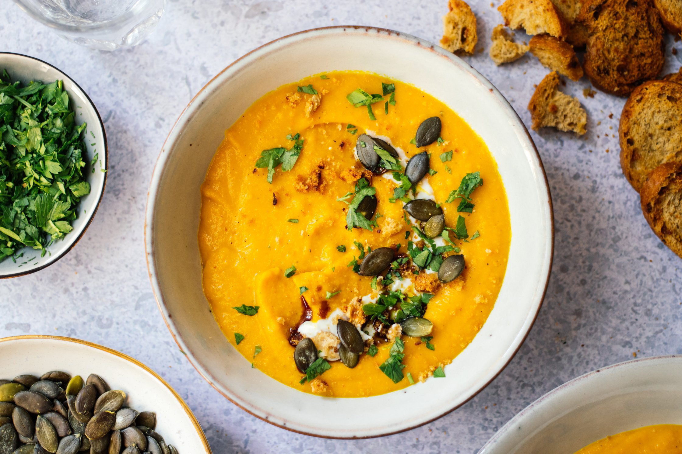 Vegan Pumpkin Soup with Turmeric with pumpkin seeds and parsley
