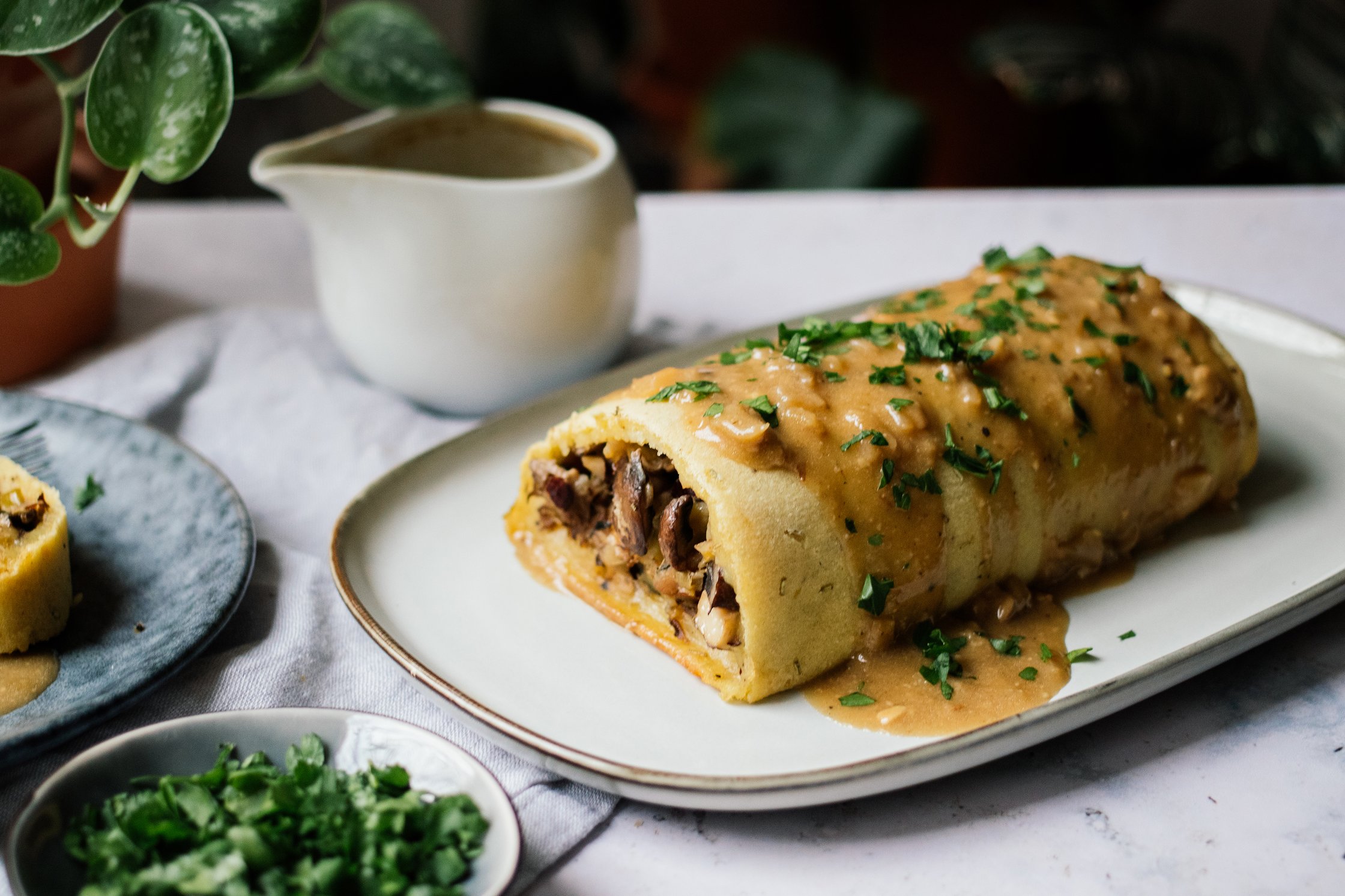 Vegan Potato Roll with Mushroom and Nut Filling and Vegan Cream Sauce ready to be served