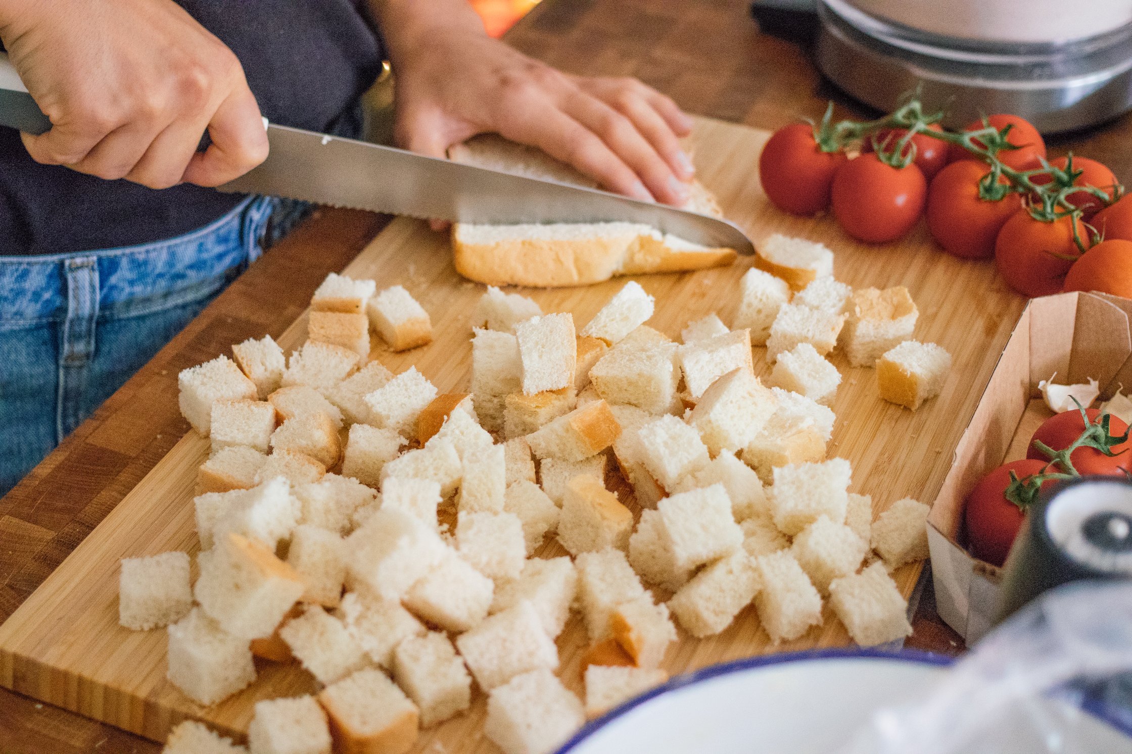 cutting white bread for vegan croutons
