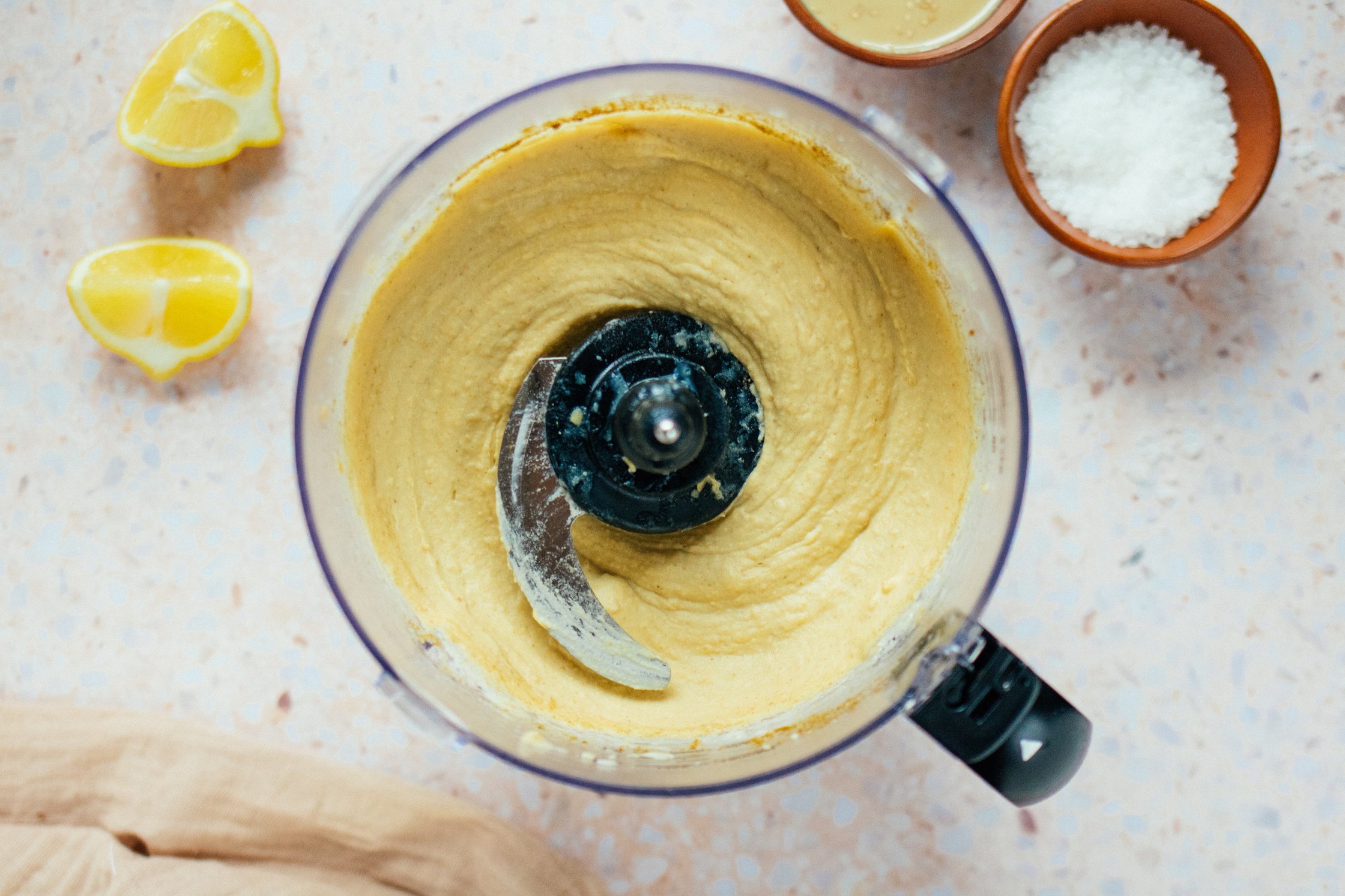 Blender with freshly blended hummus