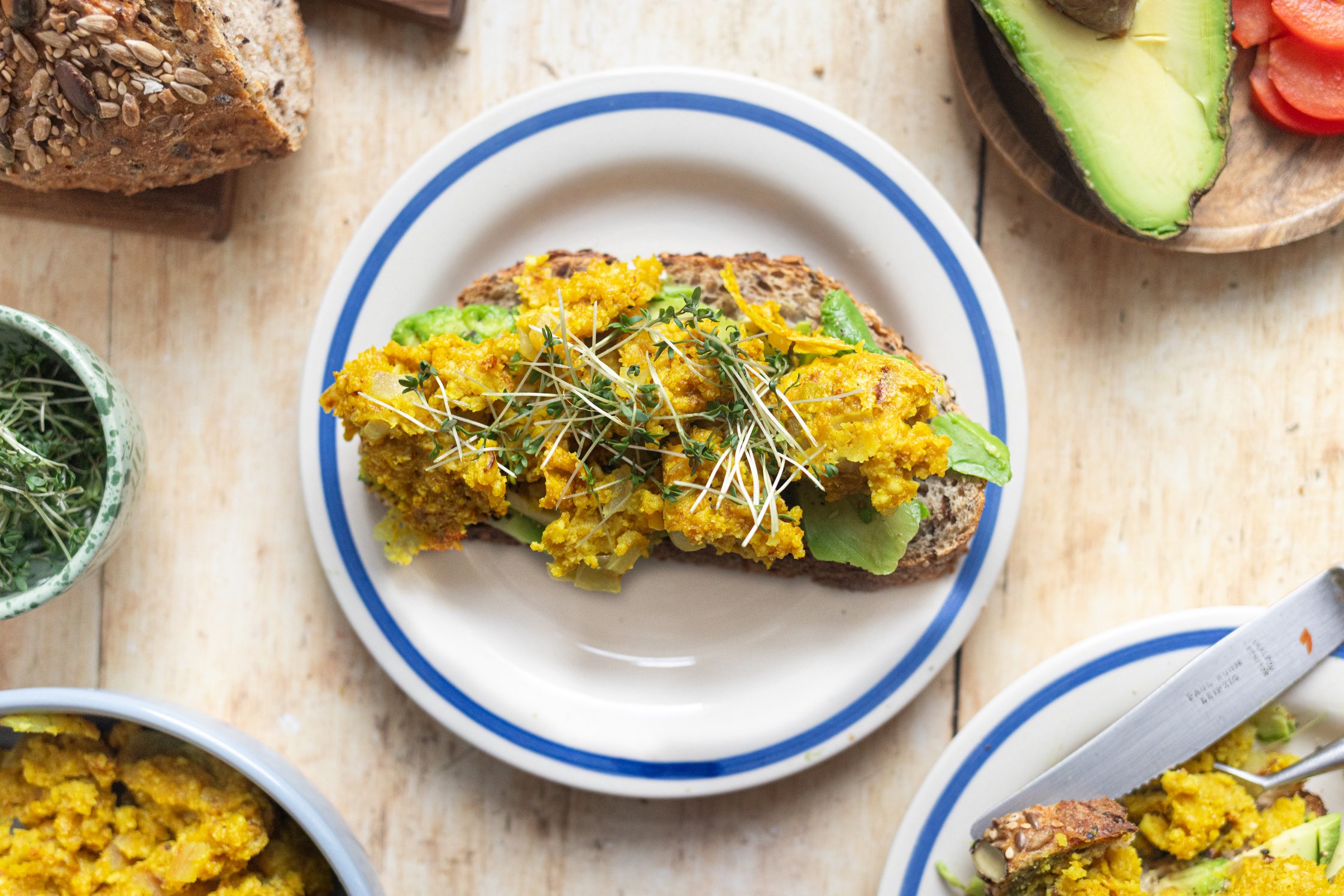 Vegan scrambled eggs on bread with avocado in the top shot.