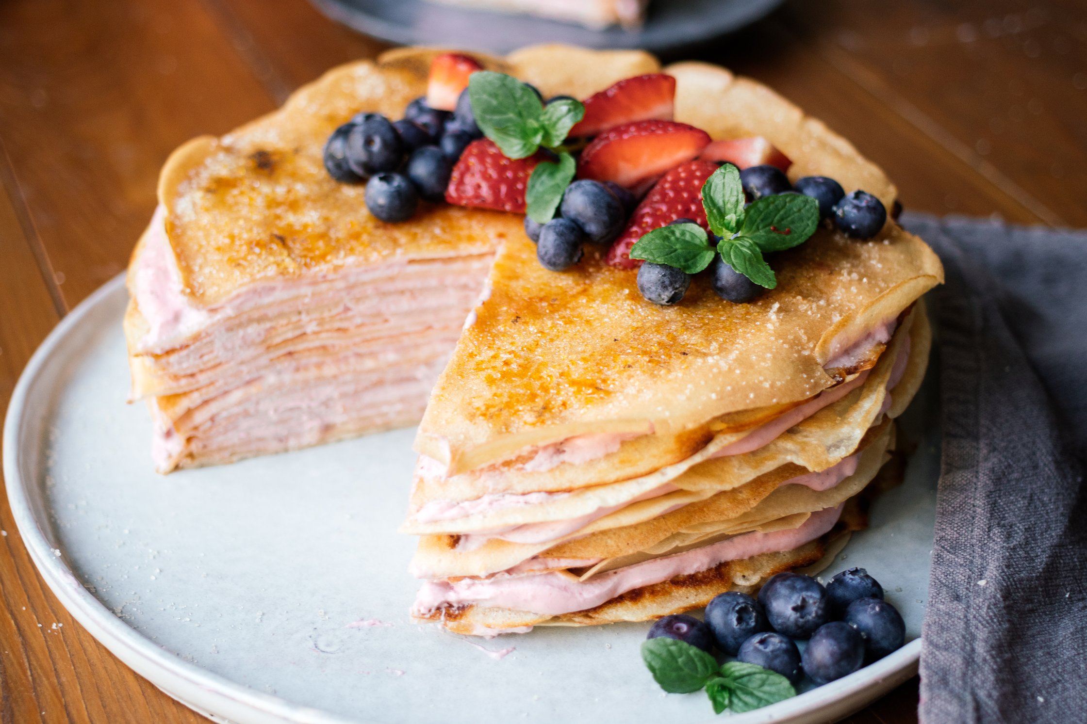 Vegan crêpe cake with strawberries cut