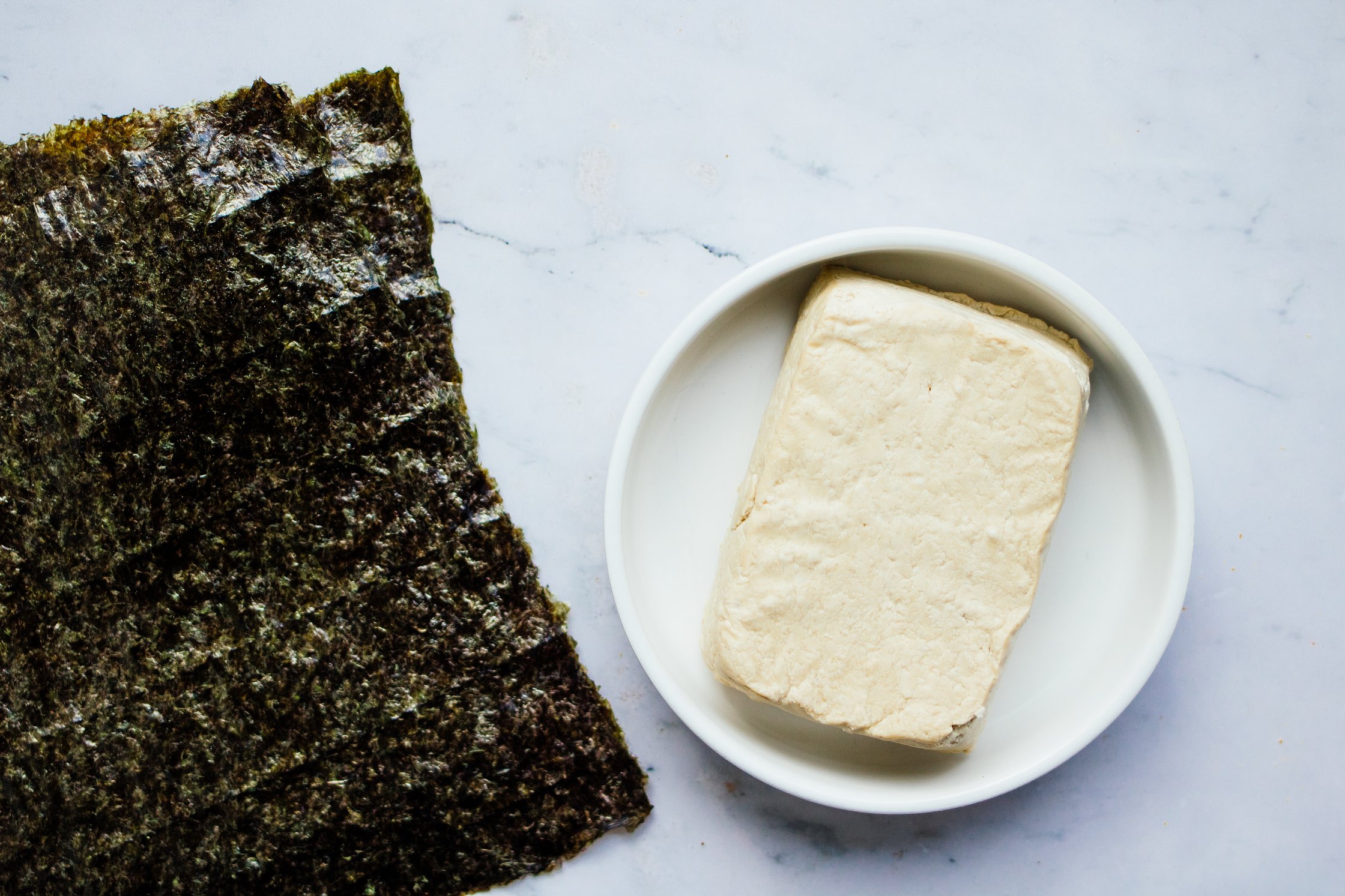 tofu next to nori sheets