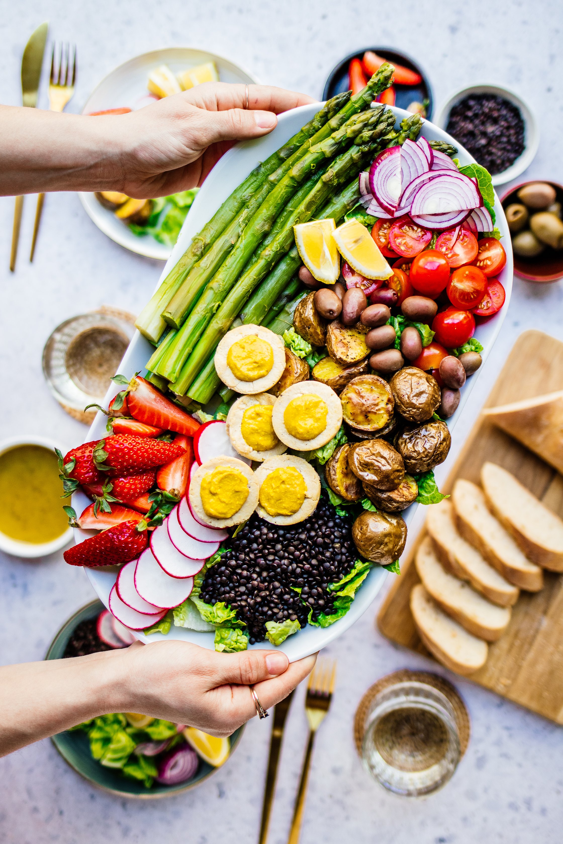 Vegan Salad with Asparagus, Lemon, Tomatos, red Onions, Potatoes and Olives
