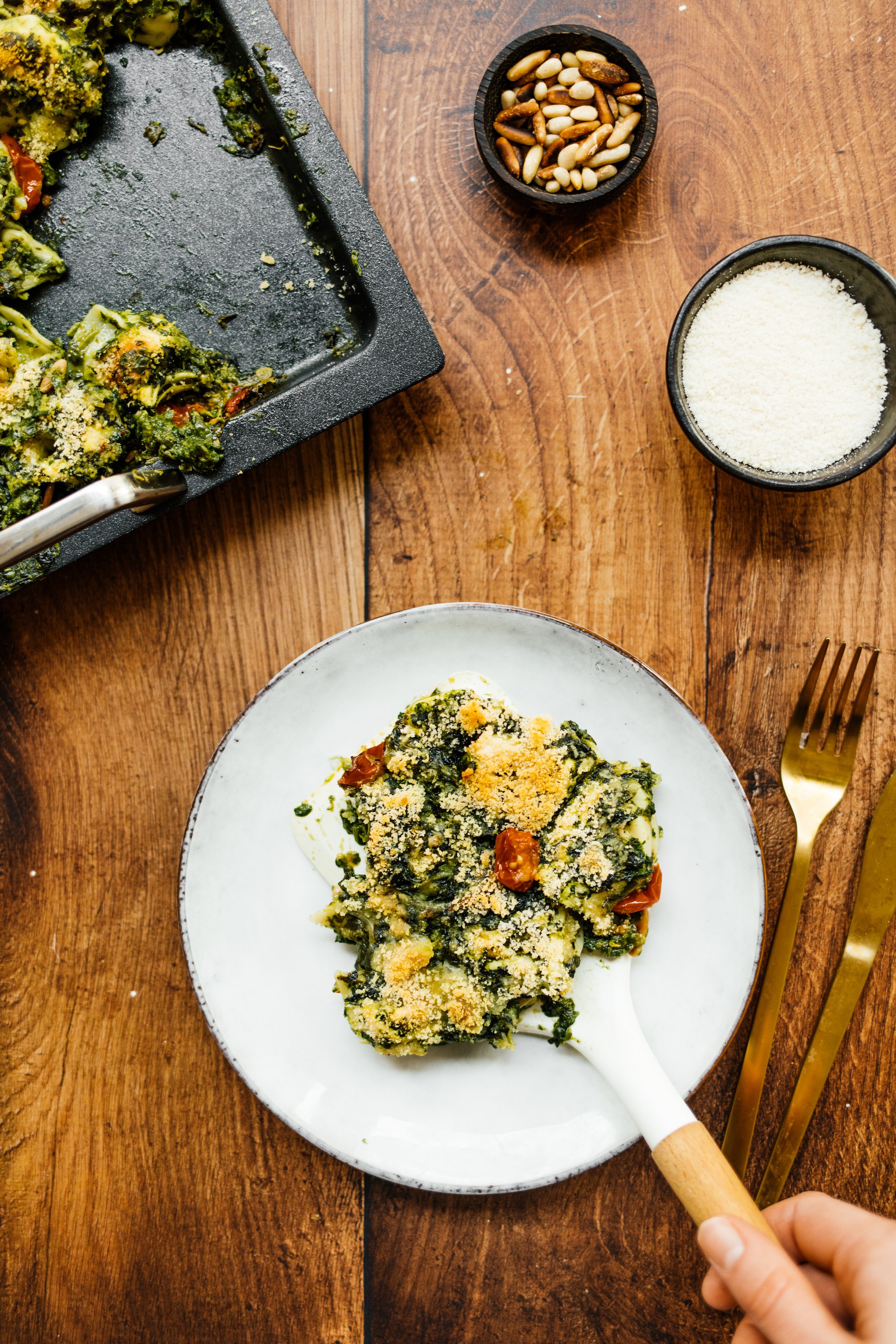 arranging vegan tortellini casserole on a plate